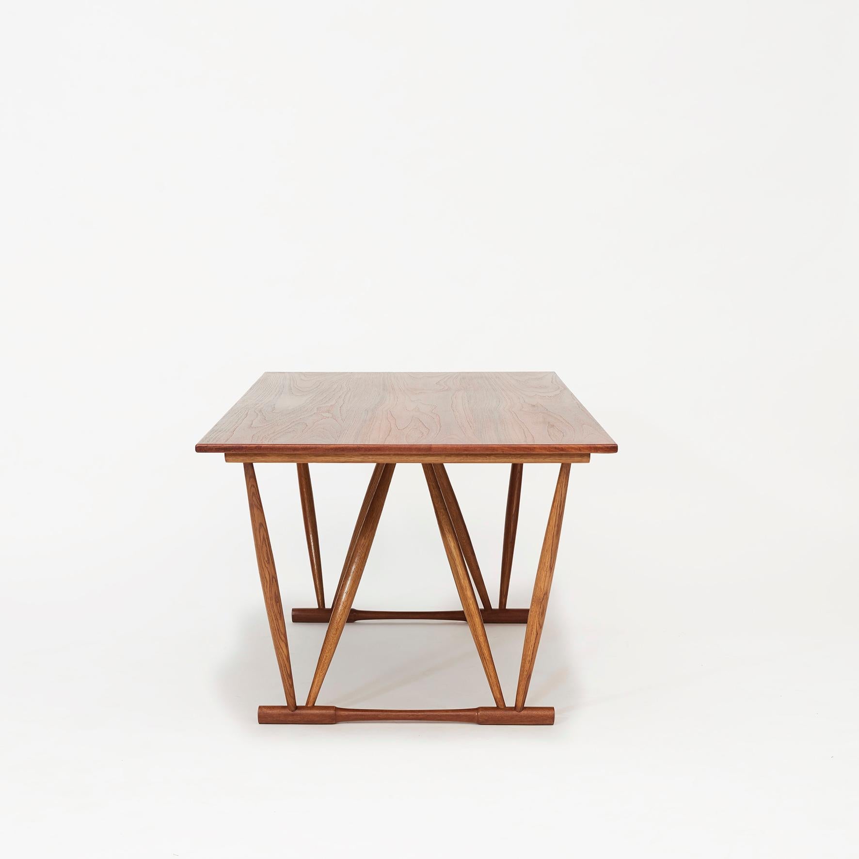 Frode Holm design.
Work table / dining table Top solid Teak. Base in Oak wood.
Sculptural V-shaped frame and a rectangular top.

Designed 1944. Manufactured for retailer Illums Bolighus.