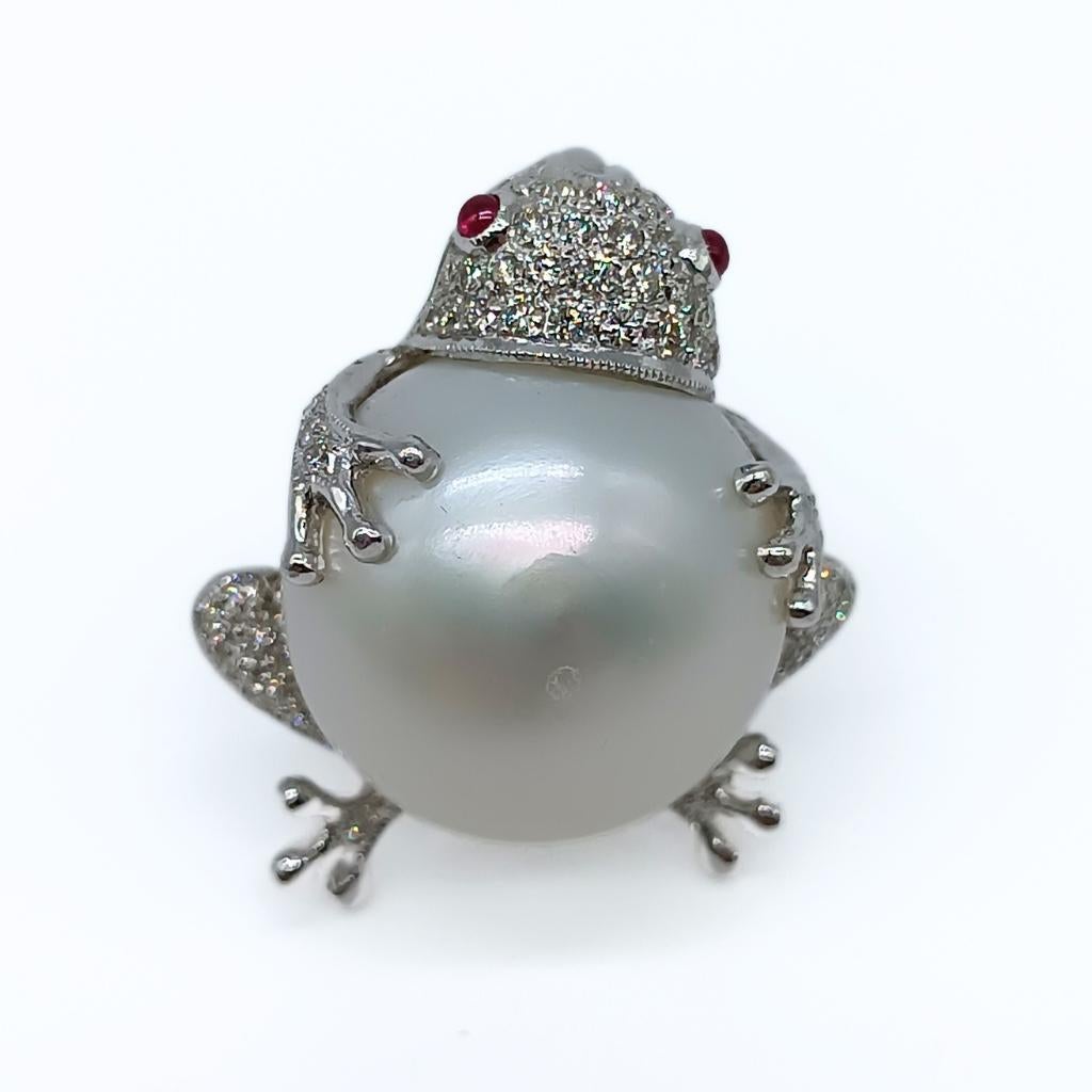 Frog Brooch 
18k White Gold 8.3gr
60 Diamonds in brilliant-cut 0.84k
2 Rubies in the eyes 0.10k
Holding a button Pearl
