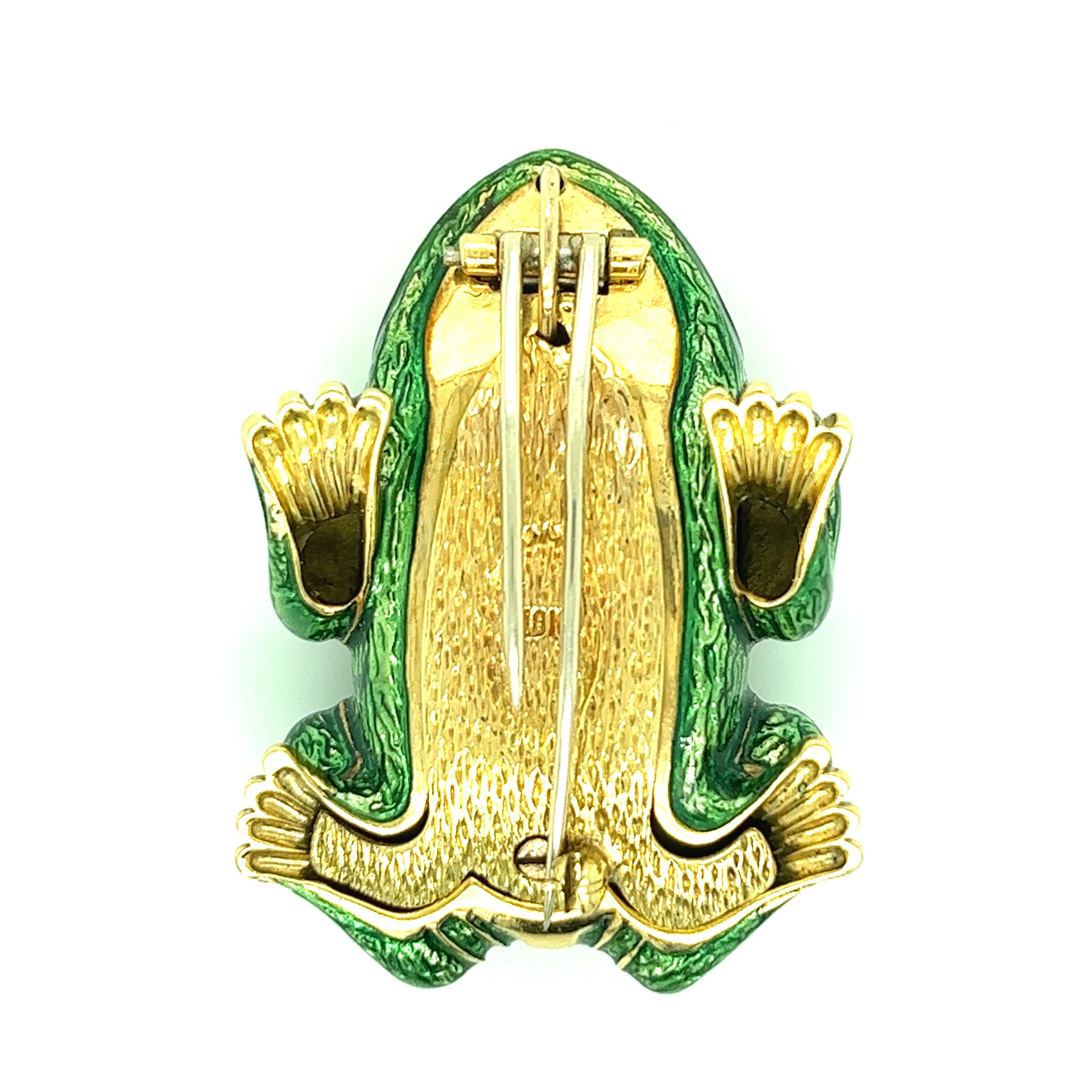 A unique brooch that features a frog made out of green enamel set on 18 karat yellow gold as well as oval rubies for eyes. Marked: 18k. Width: 1.25 inches. Length: 1.75 inches. Total weight: 38.8 grams. 