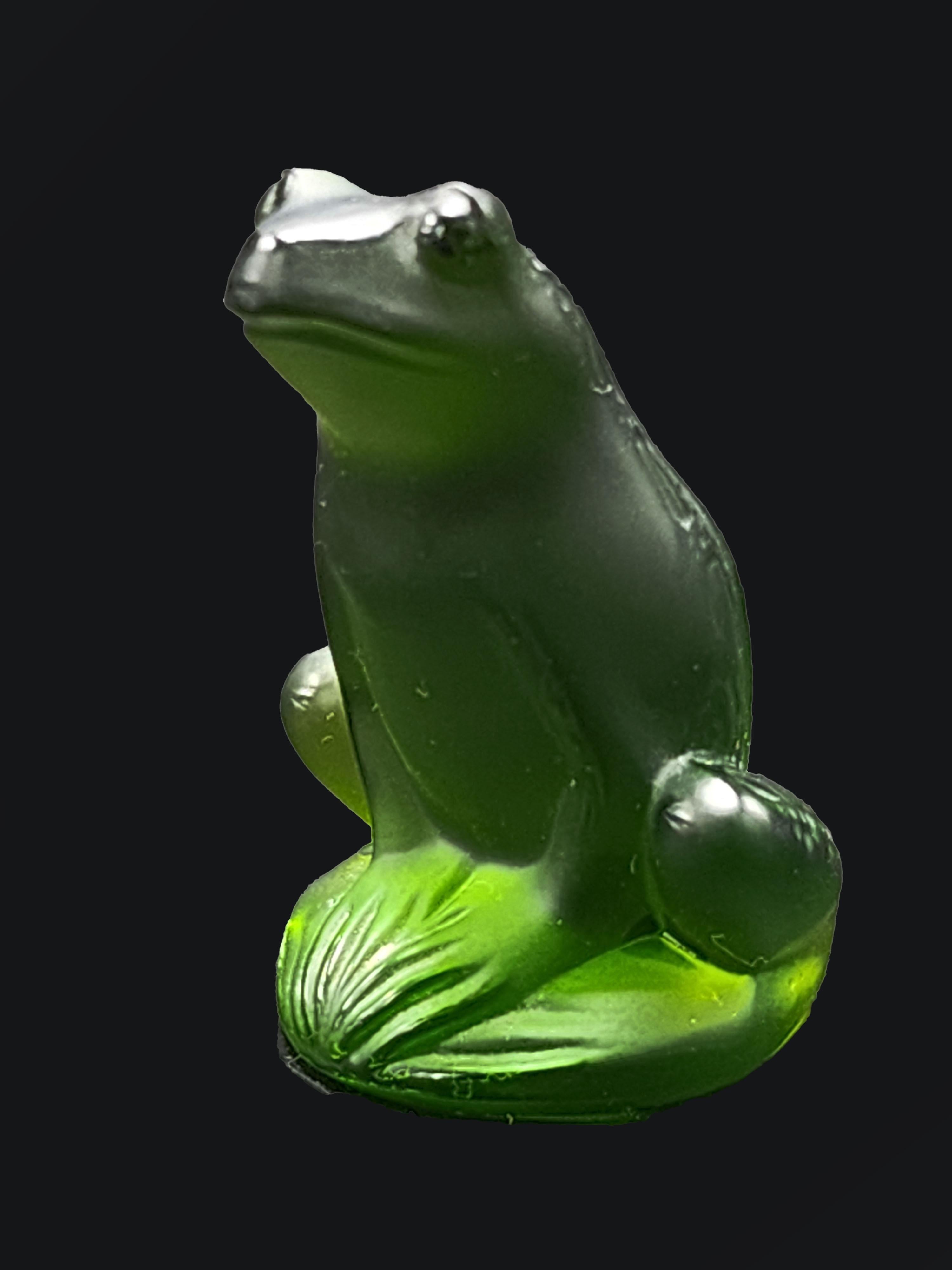 20th century Frog glass figurine by Lalique
Beautiful green artistic glass frog by Lalique, sitting and hand carved. Thanks to the quality of the carving we can appreciate its gaze and the texture of its skin on its back. Signed