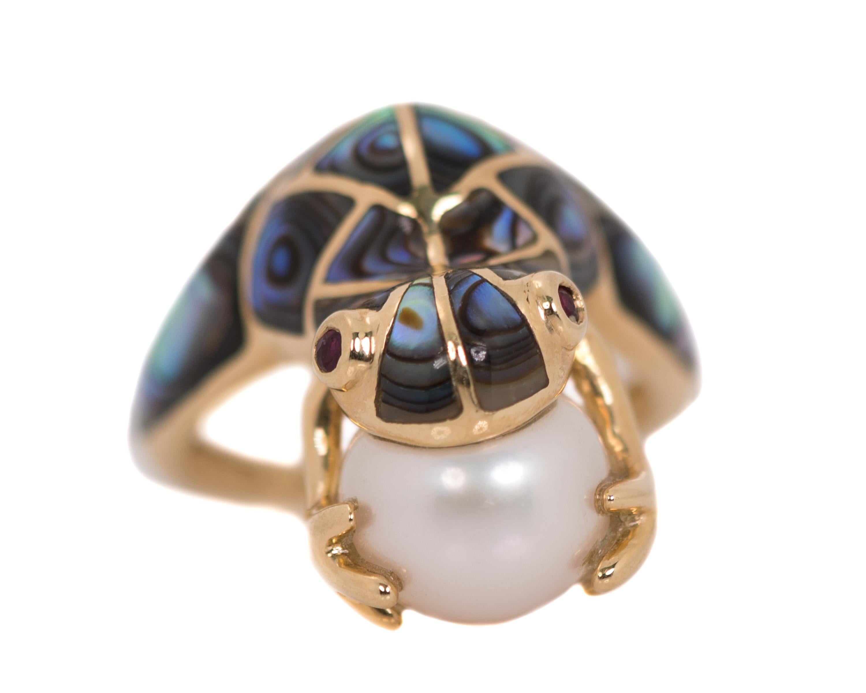 1990s Frog Ring - 14 Karat Yellow Gold, Abalone, Pearl, Ruby

Features:
10 millimeter cultured Pearl
Abalone inlay Frog body and back legs (front half of ring shank)
14 Karat Yellow Gold setting
14 Karat Yellow Gold Frog front legs
2 Ruby eyes
14