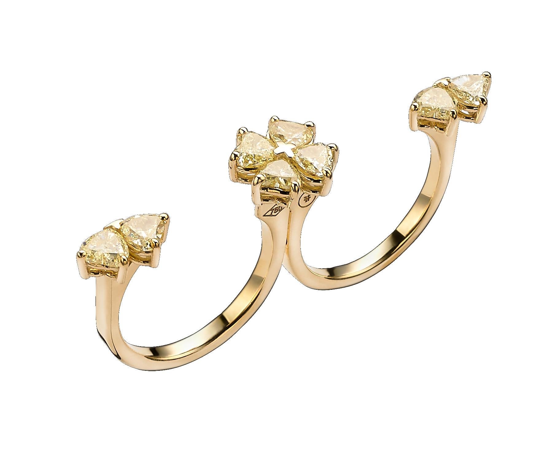 This unique ring can worn in 2 ways: 
- Closed showing 2 flowers made out of 4 heart shaped yellow diamonds each.
- Swiveled open worn on 2 fingers, showing in the center a flower and on each side a butterfly.
While closed, the ring is held together