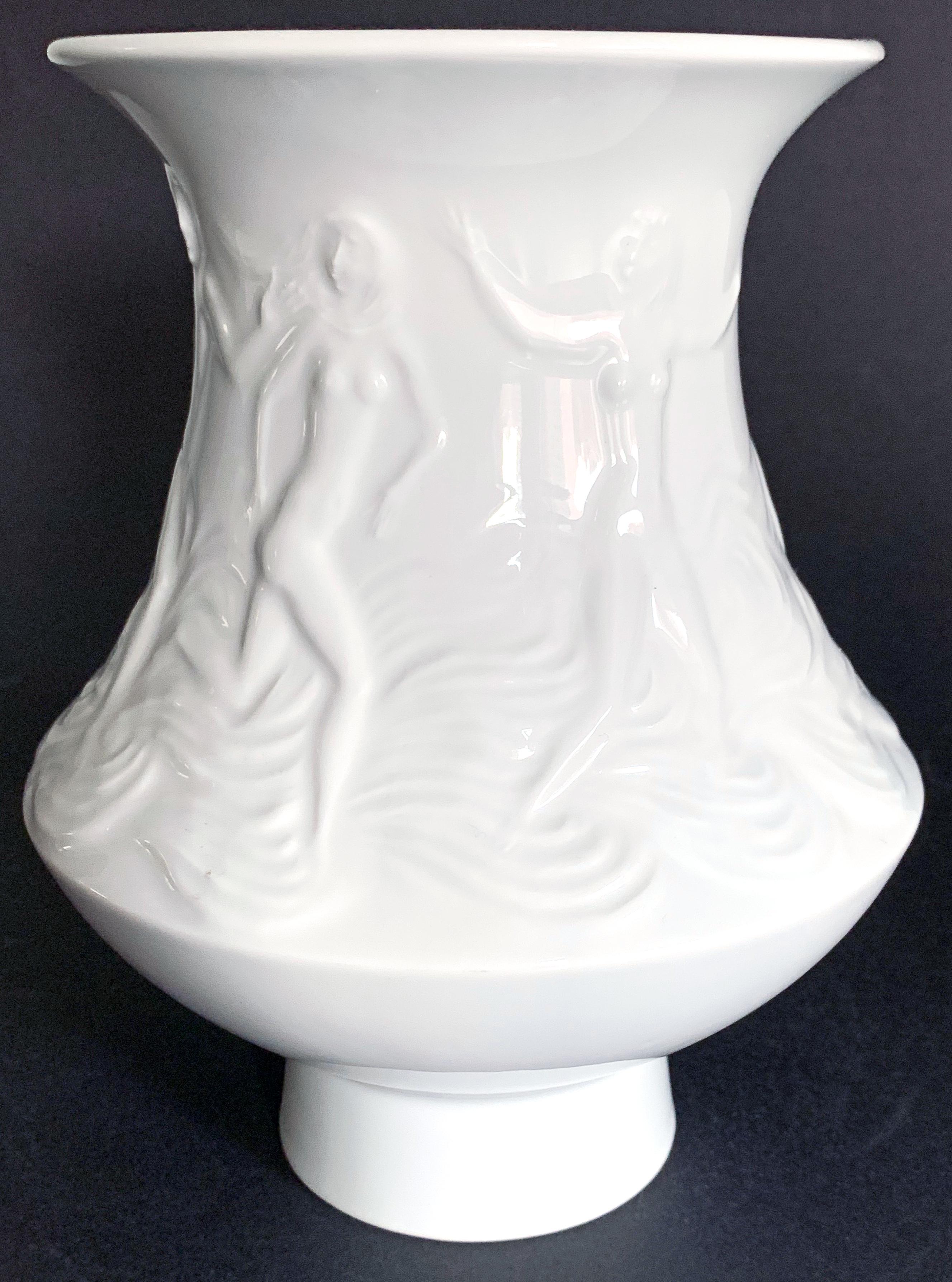 Rare and lovely, this flaring porcelain vase designed by Rudi Stolle for the famed Meissen Porcelain works depicts a bas relief frieze of nude nymphs and tritons frolicking in the ocean. Stolle worked at Meissen briefly in the 1930s before returning