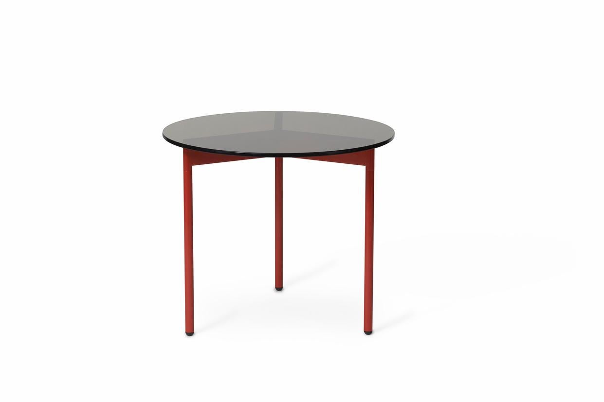 From Above side table smoke brown glass rusty red by Warm Nordic
Dimensions: D 52 x H 45 cm
Material: Tempered glass top, Powder coated steel legs.
Weight: 8.5 kg
Also available in different finishes and dimensions.

A light, elegant coffee