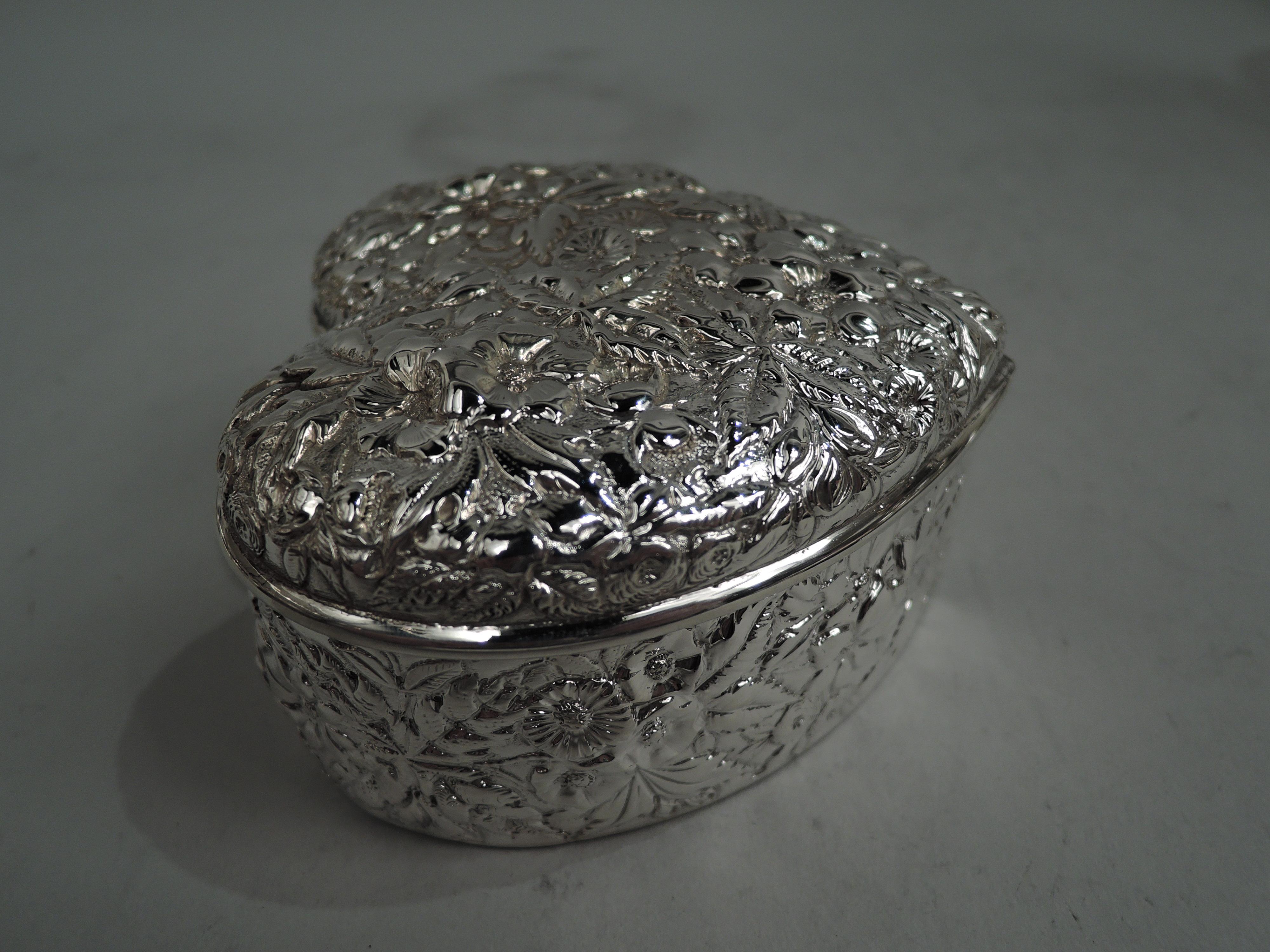 Victorian sterling silver trinket box. Made by A. Jacobi & Co. in Baltimore, ca 1890. Heart-Shaped with straight sides and raised cover. Allover floral repousse. Fully marked including maker’s stamp. Weight: 7.4 troy ounces.