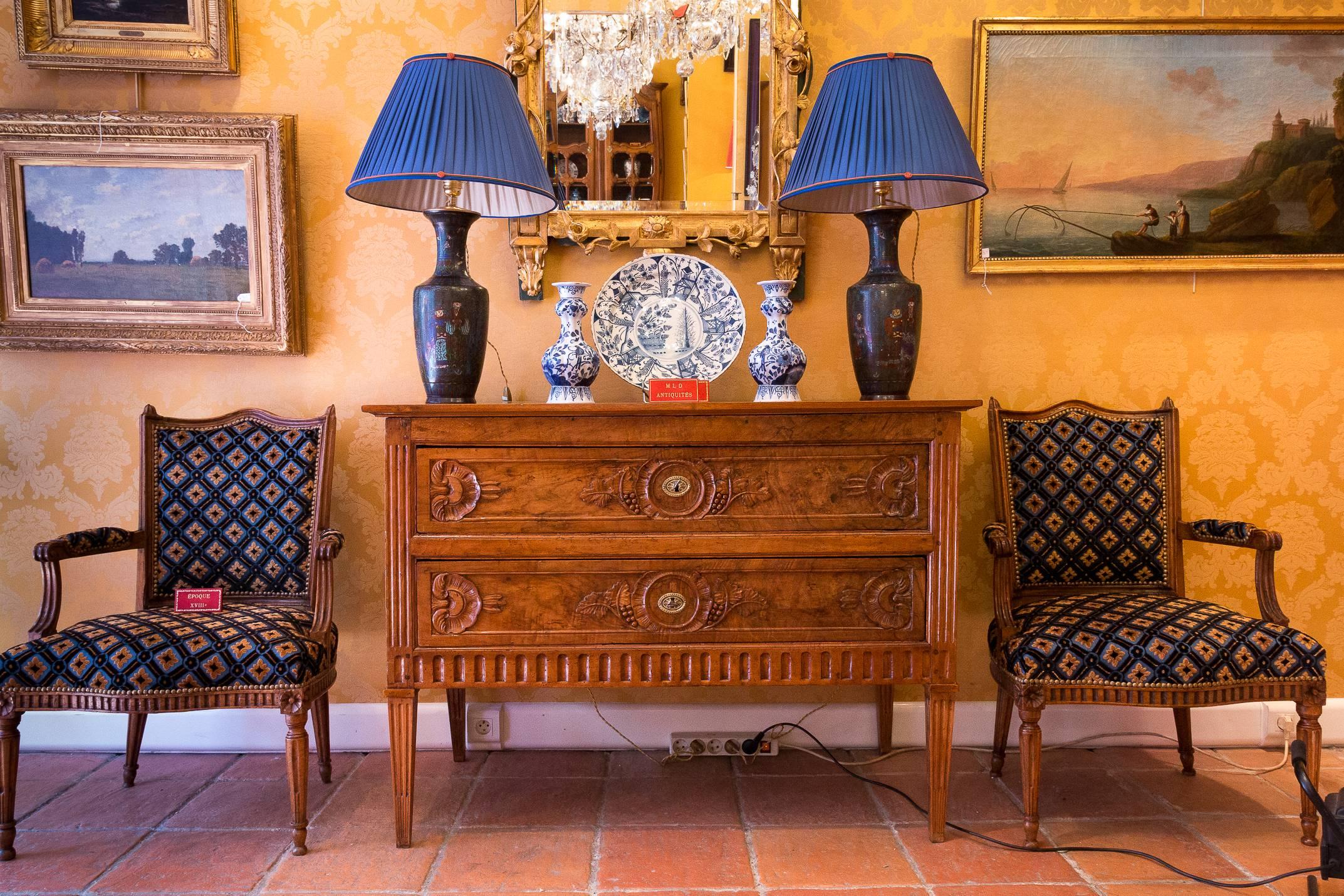 We are pleased to present you, a beautiful, elegant and rare French Louis XVI period, two-drawers in solid hand-carved walnut ornamented with vine leaves and bunches of grapes. The commode raised on four tapered legs with fluted details.

From