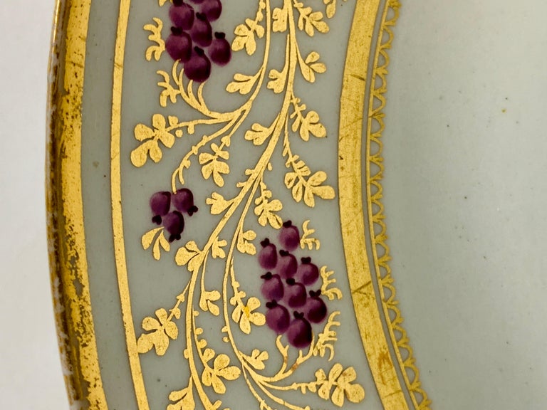 Provenance: The Private Collection of Mario Buatta
Made by New Hall in England circa 1810, this is an exquisite dish with purple berries on a golden vine.
The gilding is lavish, and the purple berries are small but beautiful.
The underside is