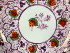 From the Collection of Mario Buatta a Pair of Pink Lustre Cups and Saucers