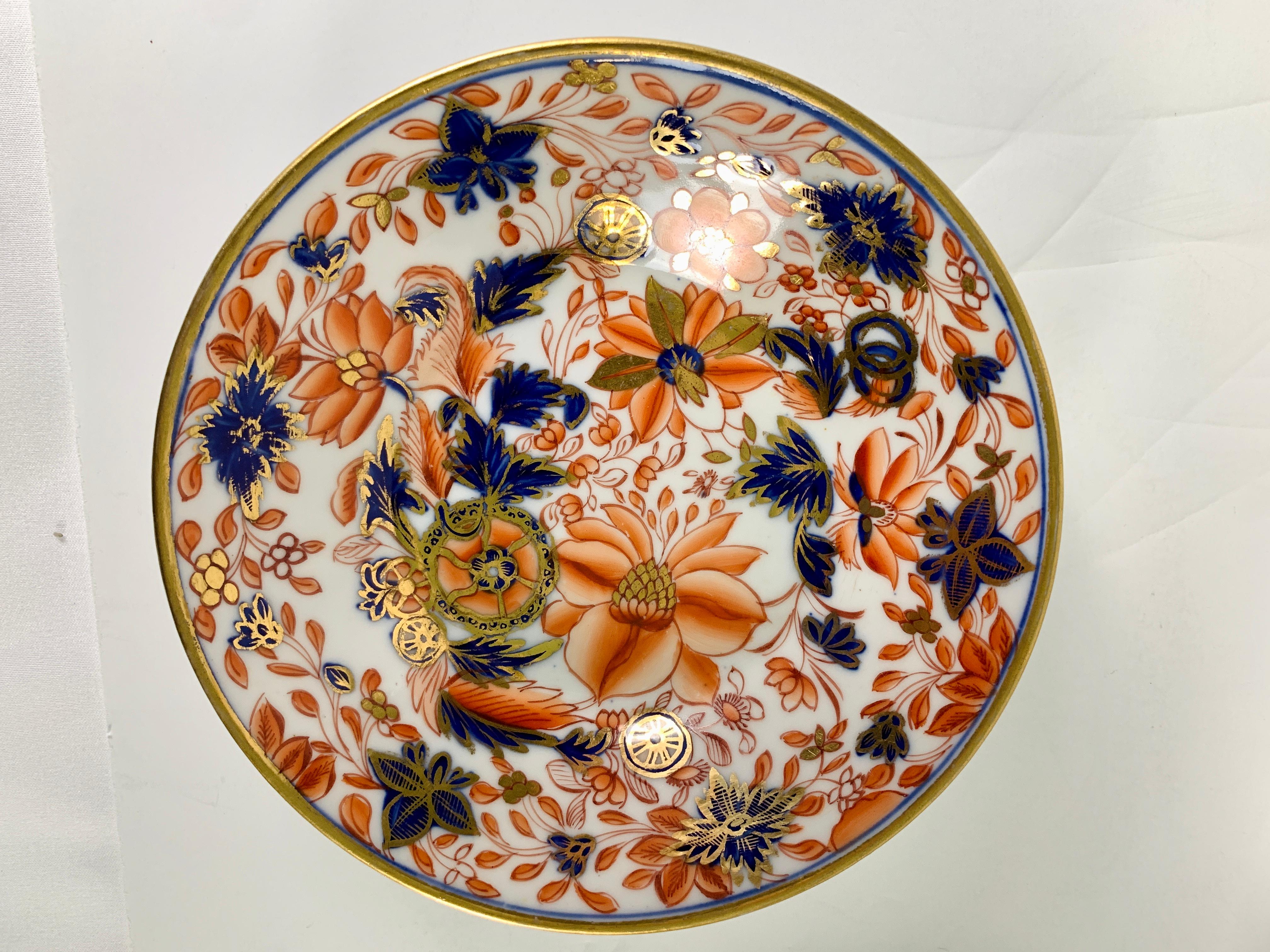 Provenance: The Private Collection of Mario Buatta 
Mario loved beautiful combinations of colors. This set of four English Tobacco Leaf pattern saucers have Imari colors which are exquisite. The saucers have a vivid palette of orange-red, cobalt