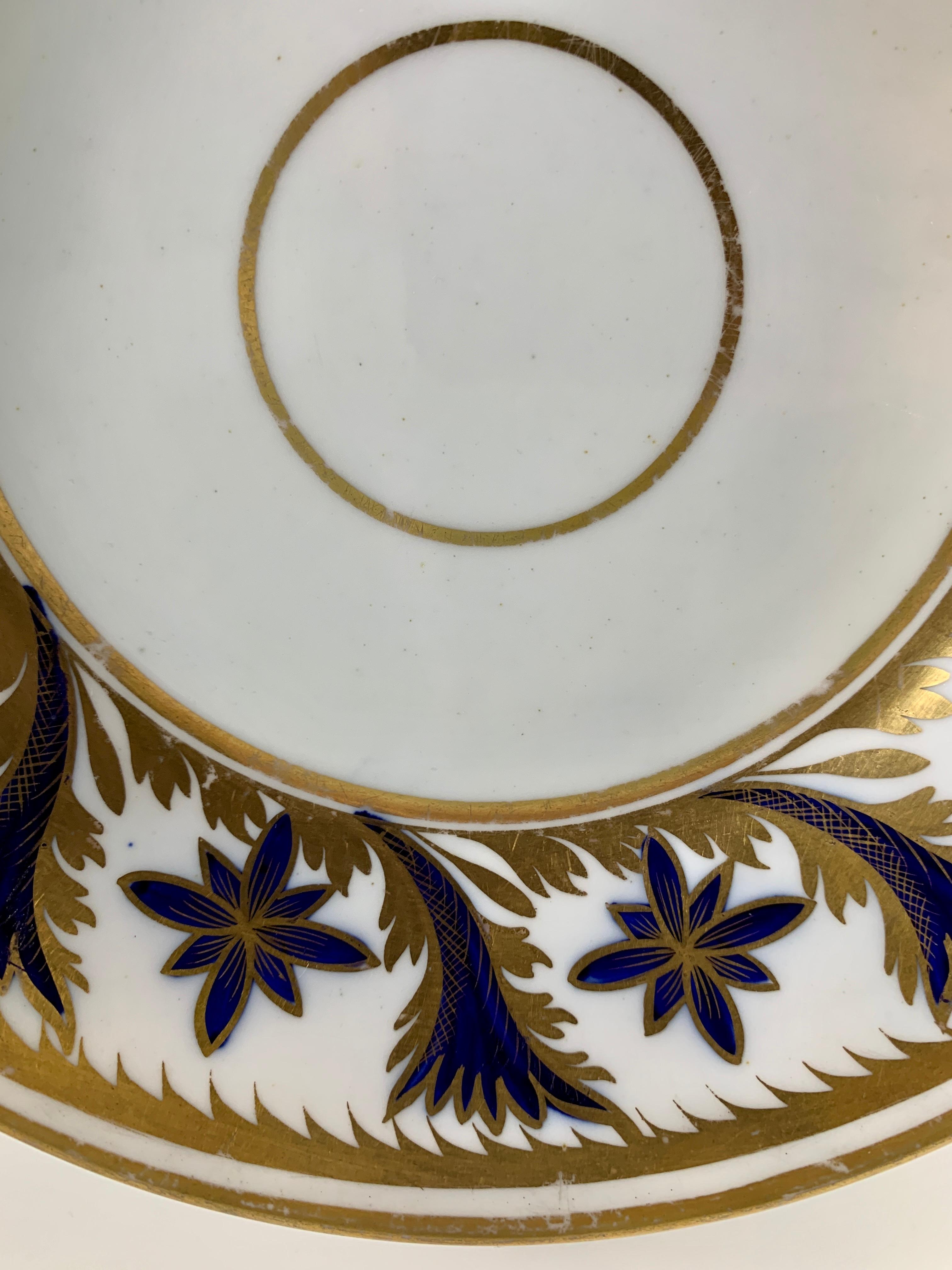 Provenance: The Private Collection of Mario Buatta
A Coalport dish with beautiful cobalt blue and gold decoration on a wide border. 
Made in England circa 1820, the dish is hand-painted and hand-gilded. 
The painter and gilder would have used a