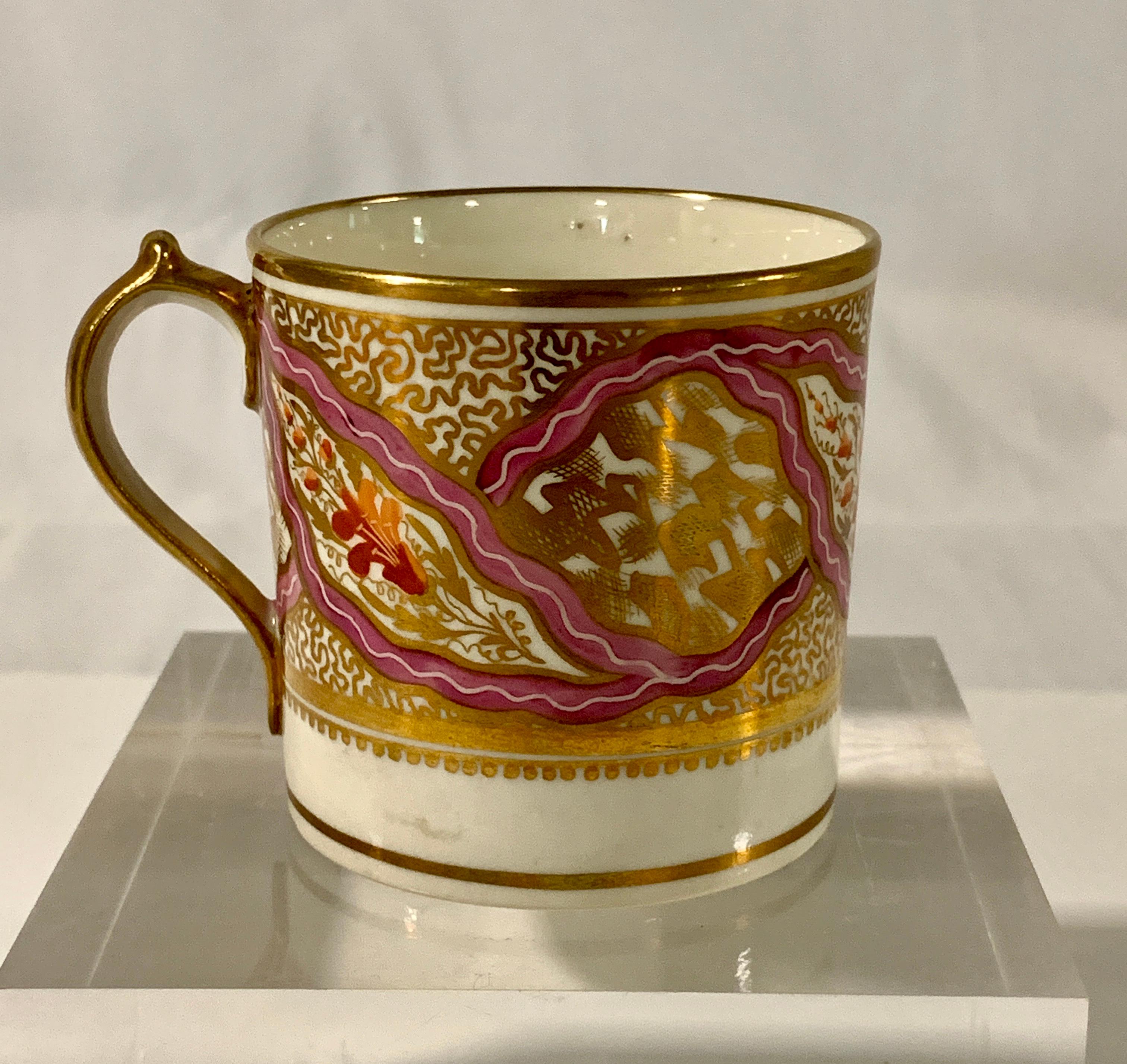 Provenance: The Collection of Mario Buatta
We purchased this porcelain cup and saucer from the estate of Mario Buatta.
 Made by Miles Mason in England circa 1805 the coffee cup and saucer have an exquisite pink ribbon design with small brick red