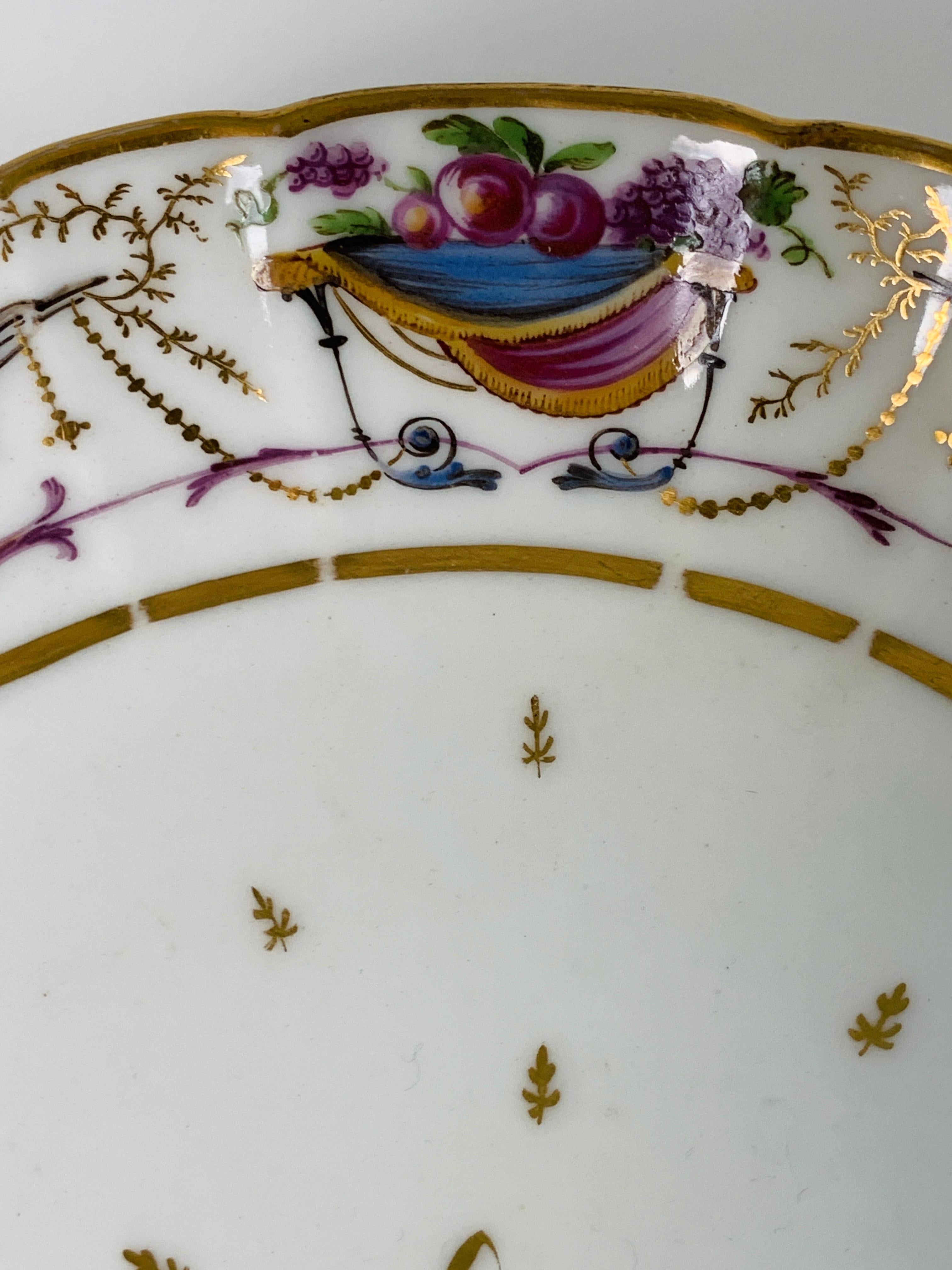 Provenance: The Private Collection of Mario Buatta
This elegant pair of dishes have fluted borders with scalloped edges.
Made in France circa 1820 the hand-painted borders are decorated with a neoclassical design showing cornucopia and flowering