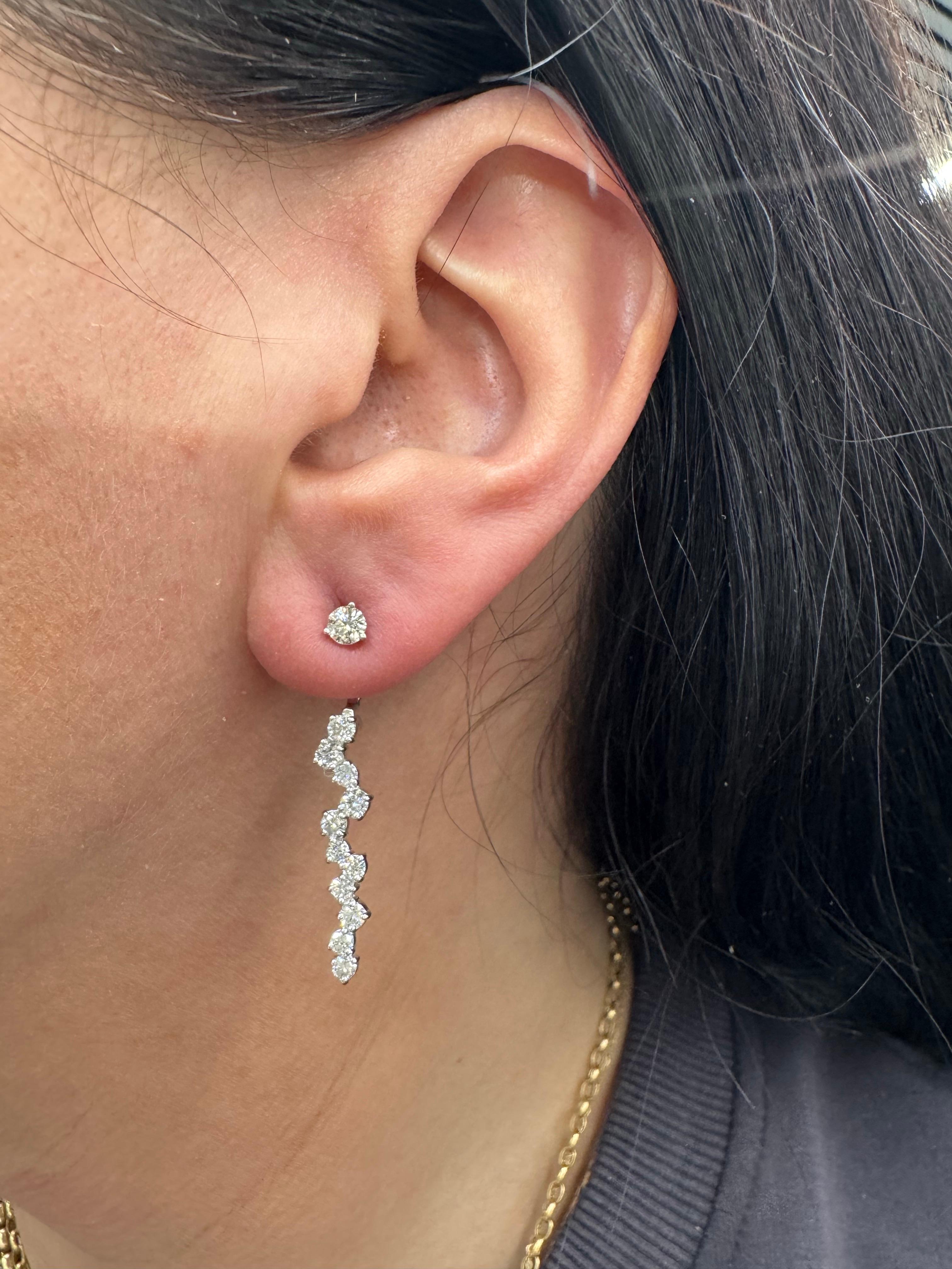 Elevate your elegance with this exquisite pair of 14K gold diamond earrings featuring a stunning combination of classic and contemporary design. Each earring showcases a brilliant VS2-grade diamond stud, leading into a graceful drop line of 23