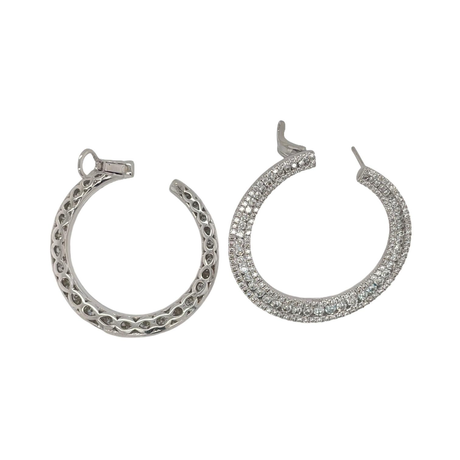 Spectacular front facing diamond hoops in 18k white gold. Earrings contain round brilliant diamonds, 3.62tcw. Diamonds are colorless and VS2 in clarity. All stones are mounted in a handmade pave style setting. Hoops measures 33mm wide and contains a