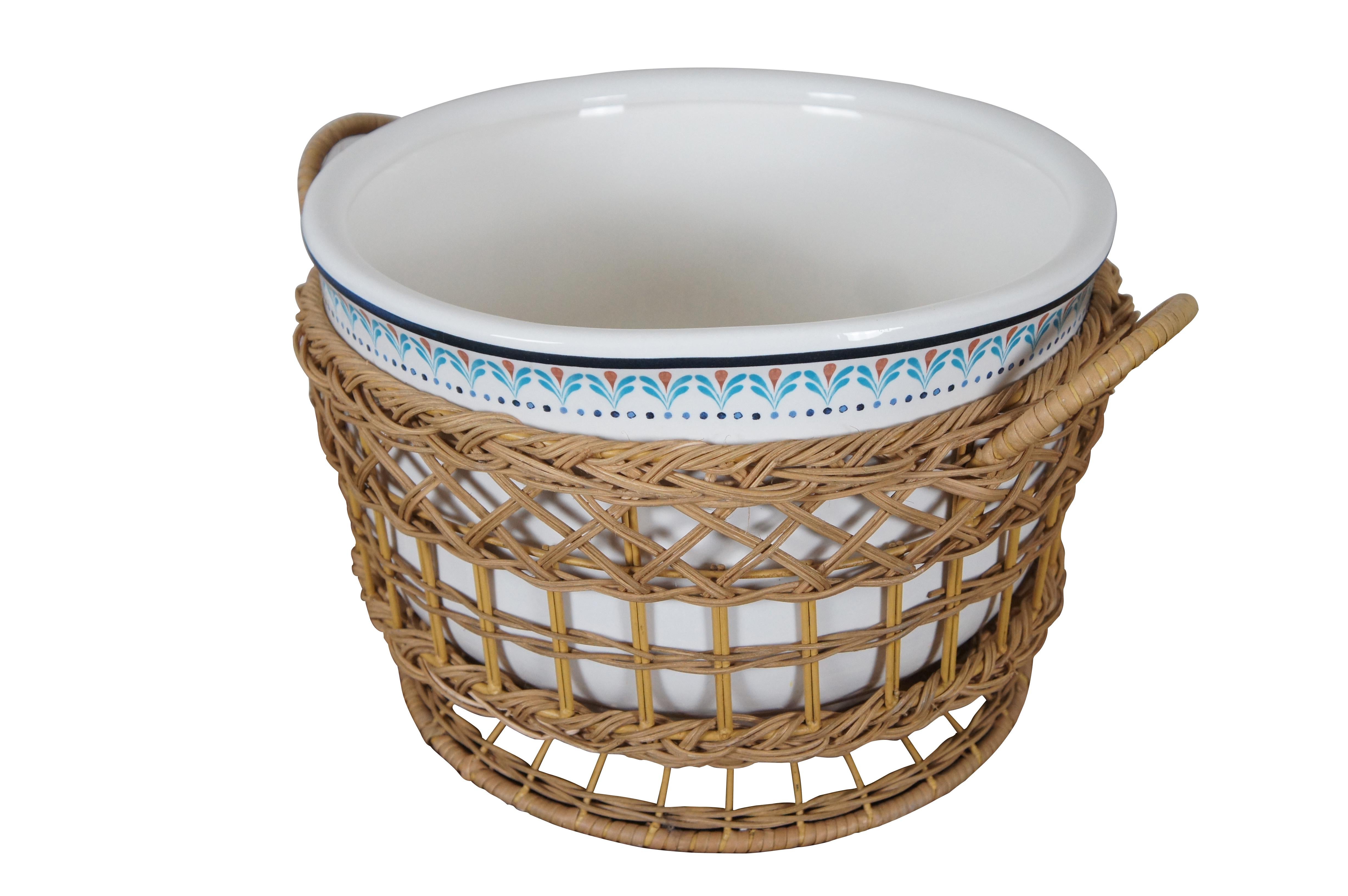 An upbeat tone for any gathering with a vibrantly hand painted floral motif and handwoven rattan. The simple artisanal charm and complementary colors of the handcrafted ceramic piece will pair beautifully with other tableware.

Dimensions:
19