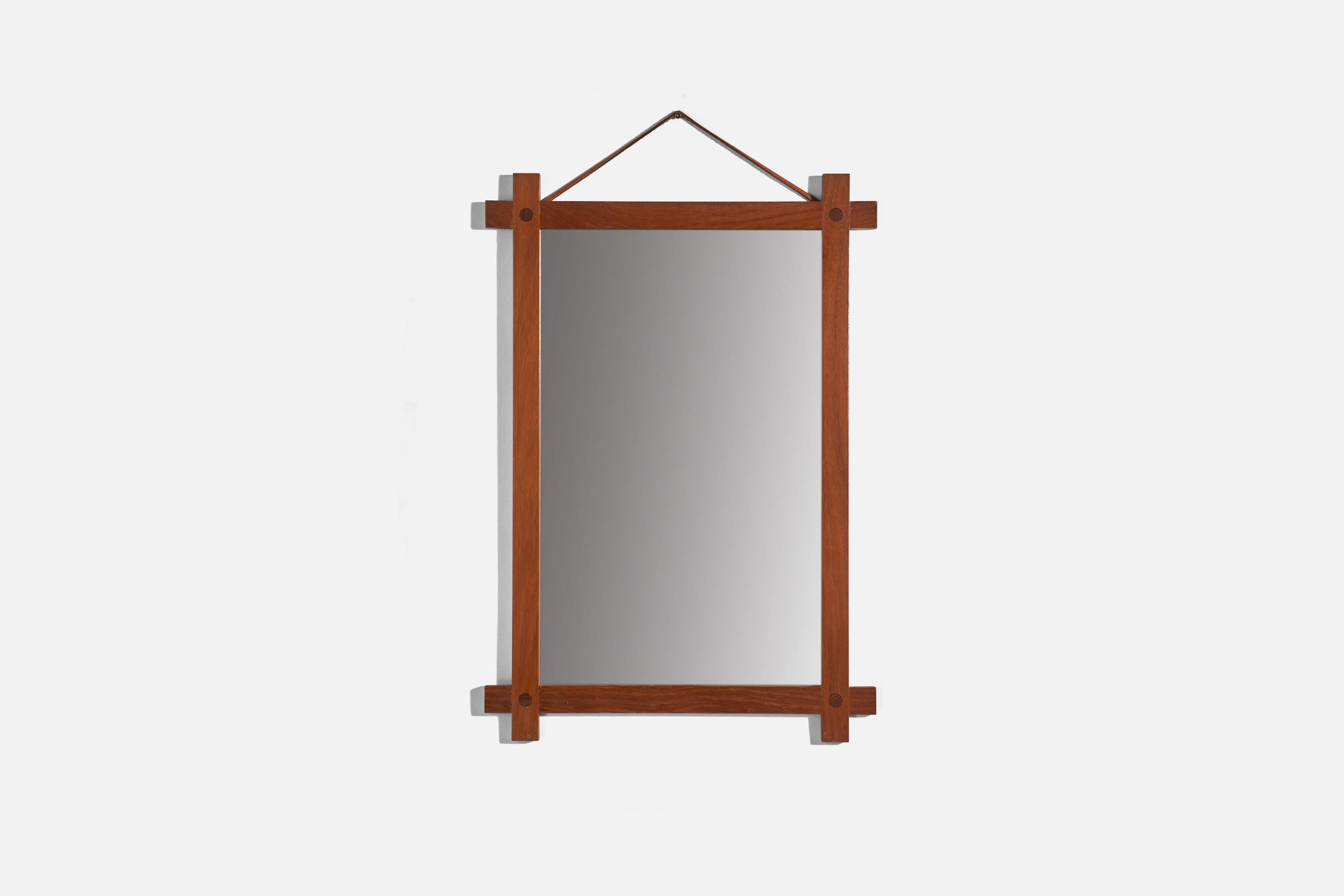 A solid teak and leather wall mirror designed and produced by Fröseke, AB Nybrofabriken, Sweden, 1960s. Labeled.

