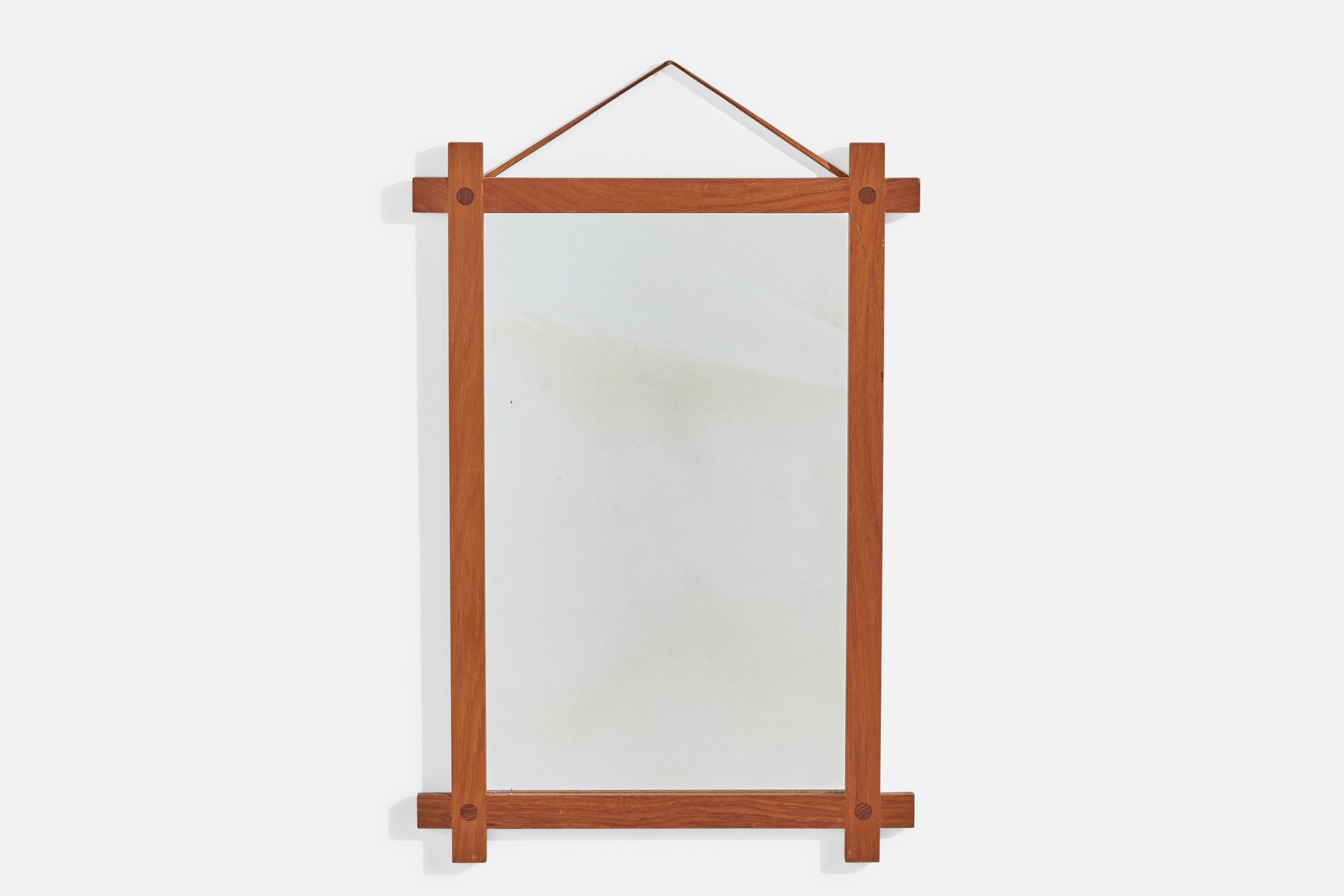 A solid teak and leather wall mirror designed and produced by Fröseke, AB Nybrofabriken, Sweden, 1960s. Labeled.

