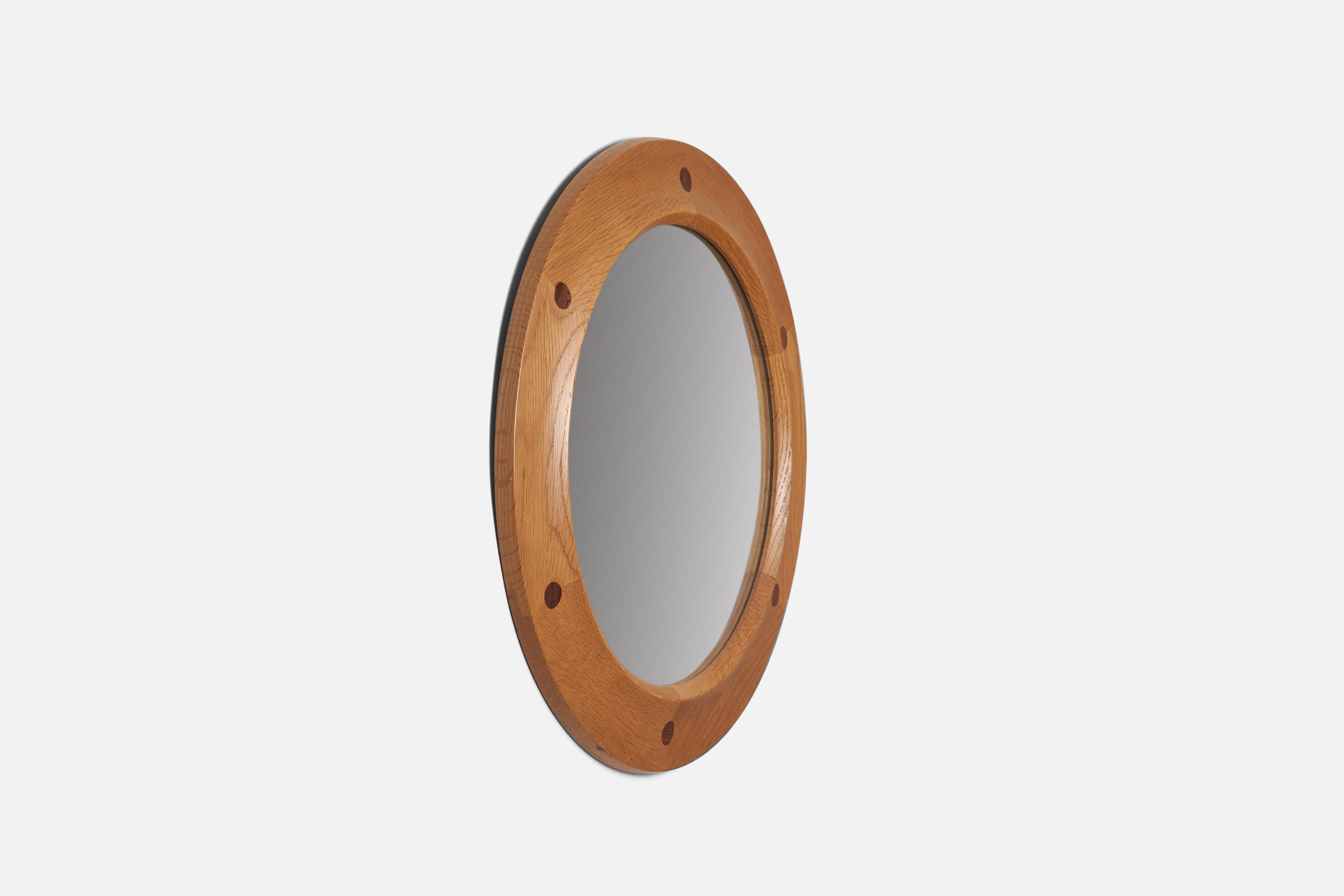 A stained oak and teak wall mirror designed and produced by Fröseke, AB Nybrofabriken, Sweden, 1950s.