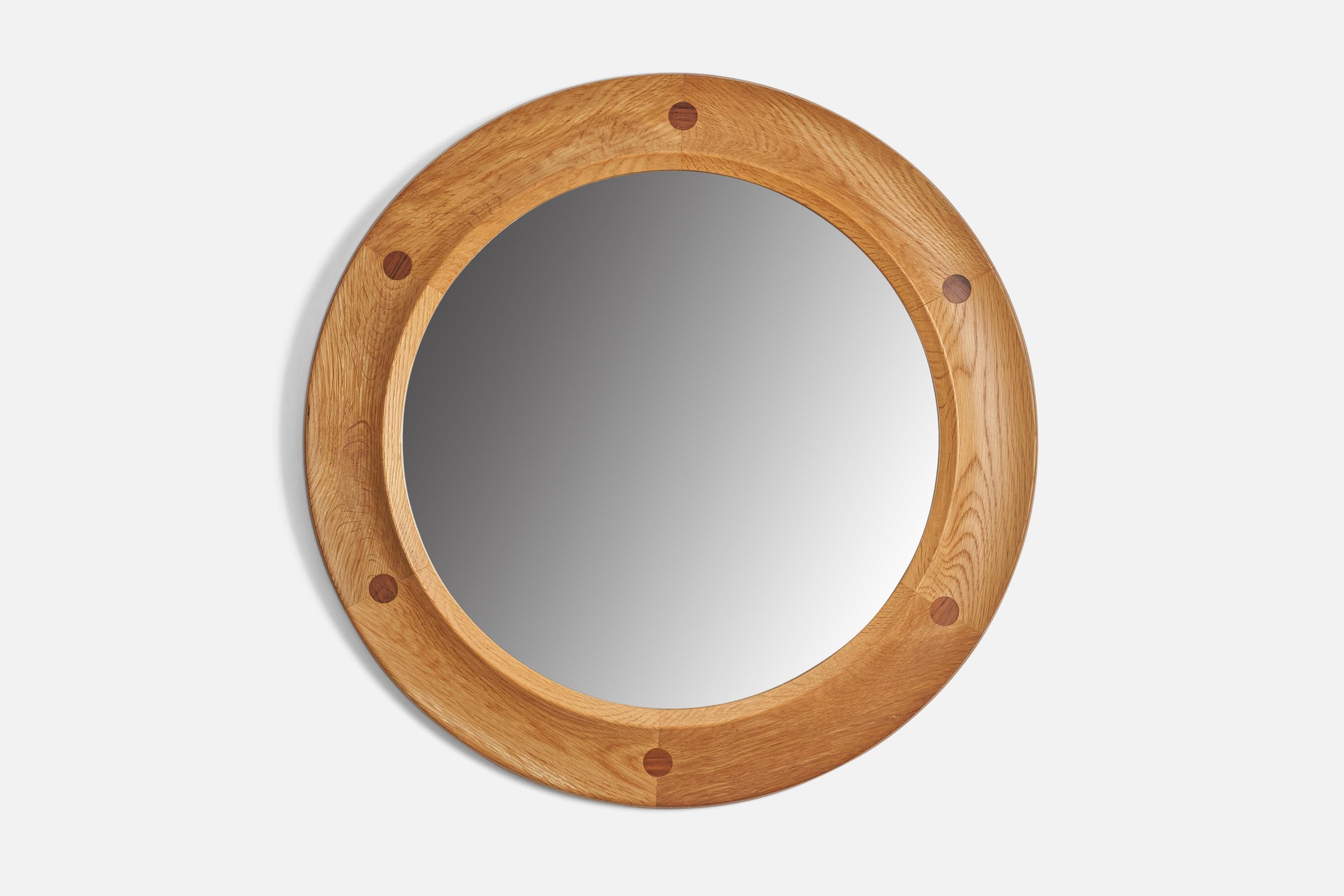 An oak and rosewood wall mirror designed and produced by Fröseke Nybrofabriken, Sweden, 1960s.