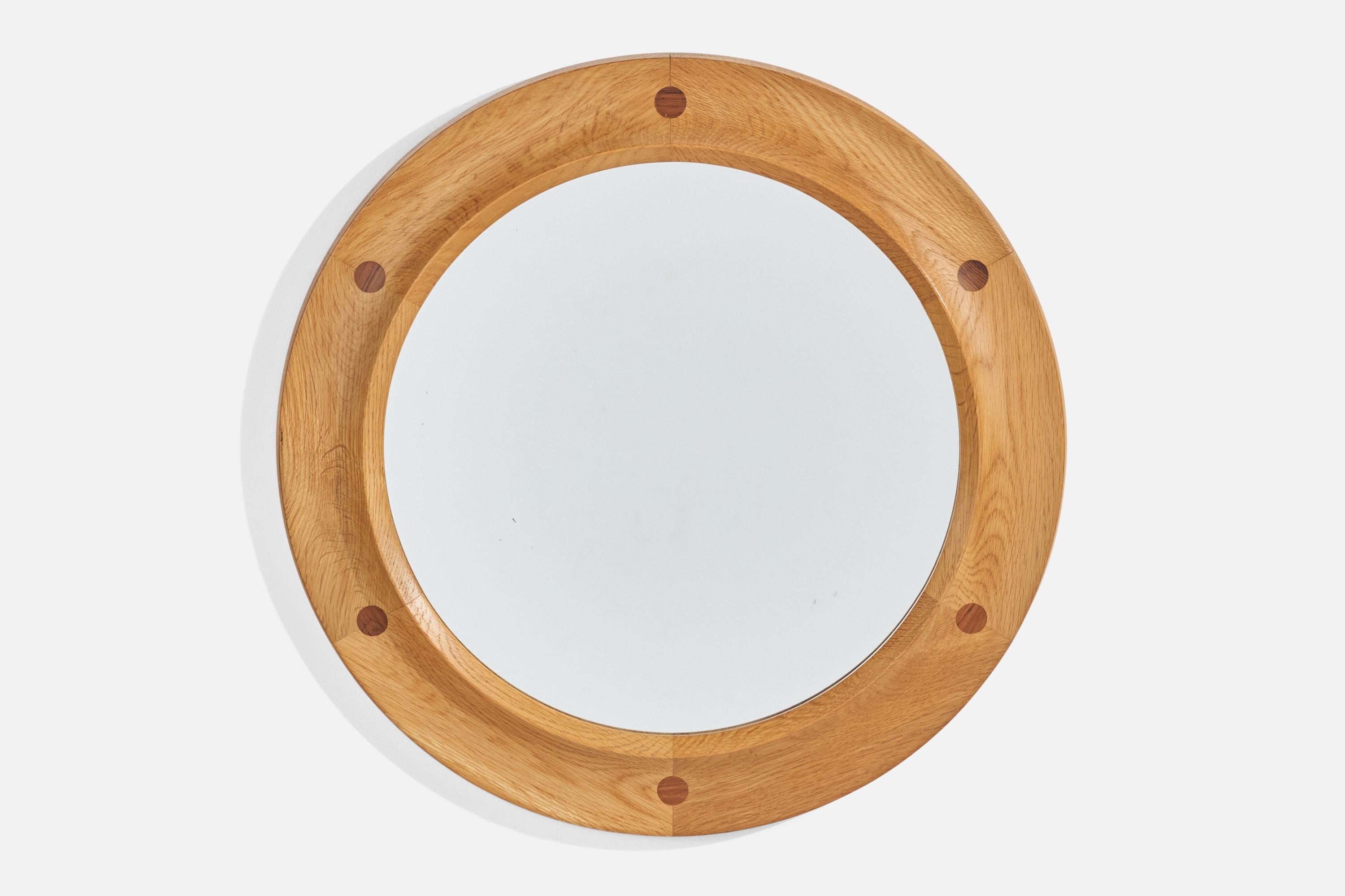 An oak and rosewood wall mirror designed and produced by Fröseke Nybrofabriken, Sweden, 1960s.