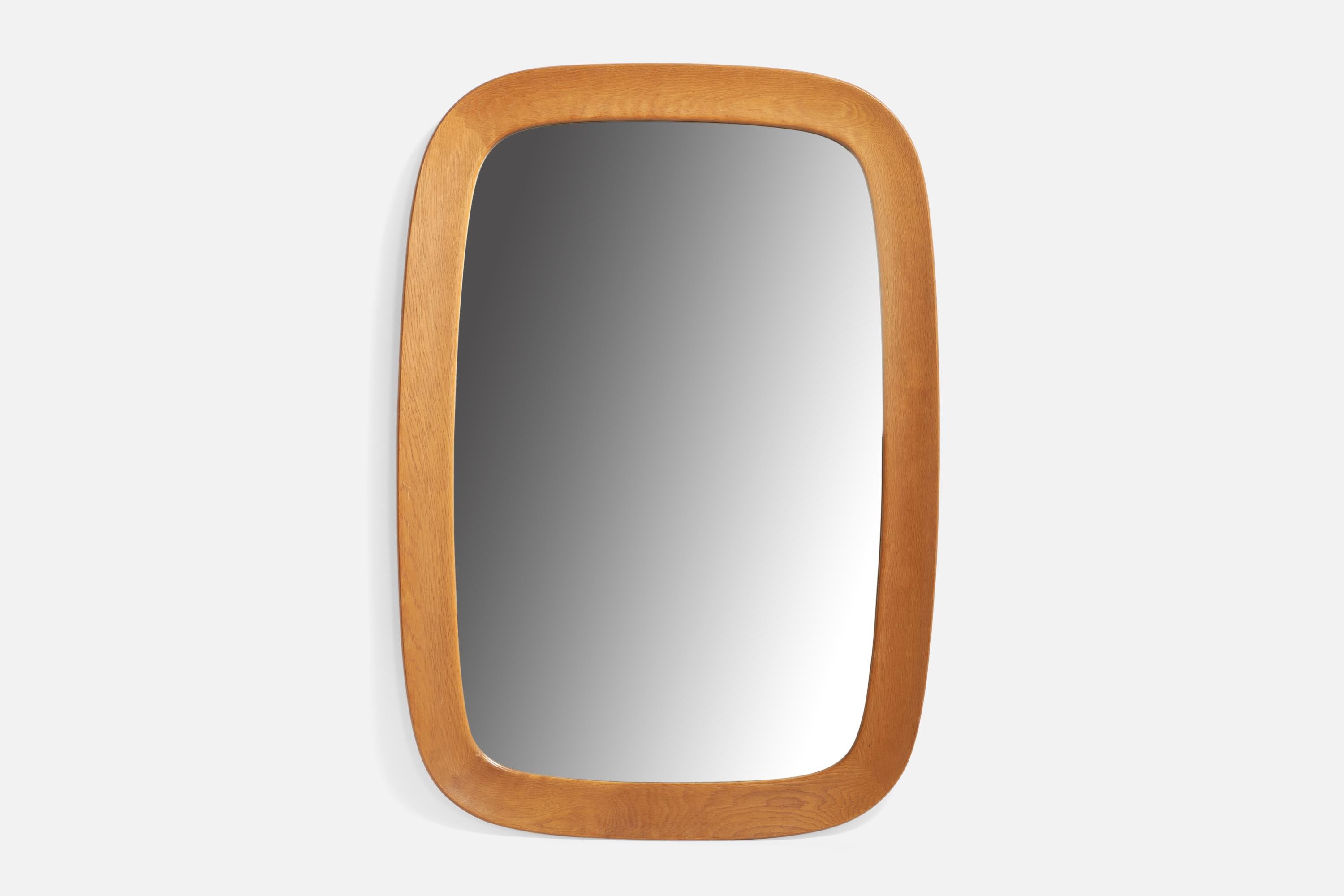 A sizeable oak wall mirror designed and produced by Fröske AB Nybrofabriken, Sweden, c. 1960s.