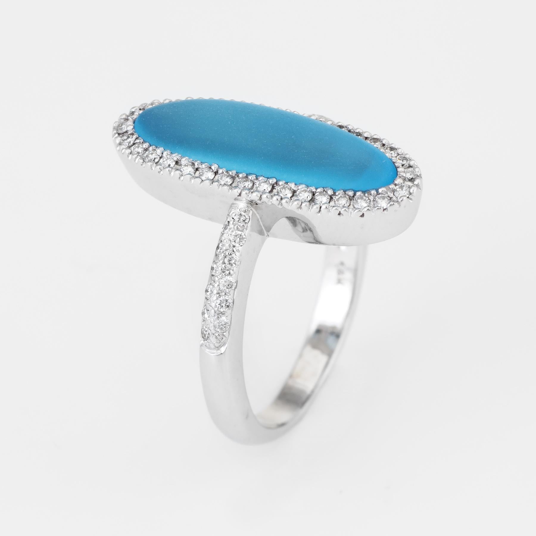Finely detailed estate cocktail ring, crafted in 14 karat white gold. 

Frosted blue topaz measures 18mm x 5mm (estimated at 3.50 carats), accented with an estimated 0.29 carats (estimated at H-I color and VS2-SI1 clarity). The topaz is in excellent