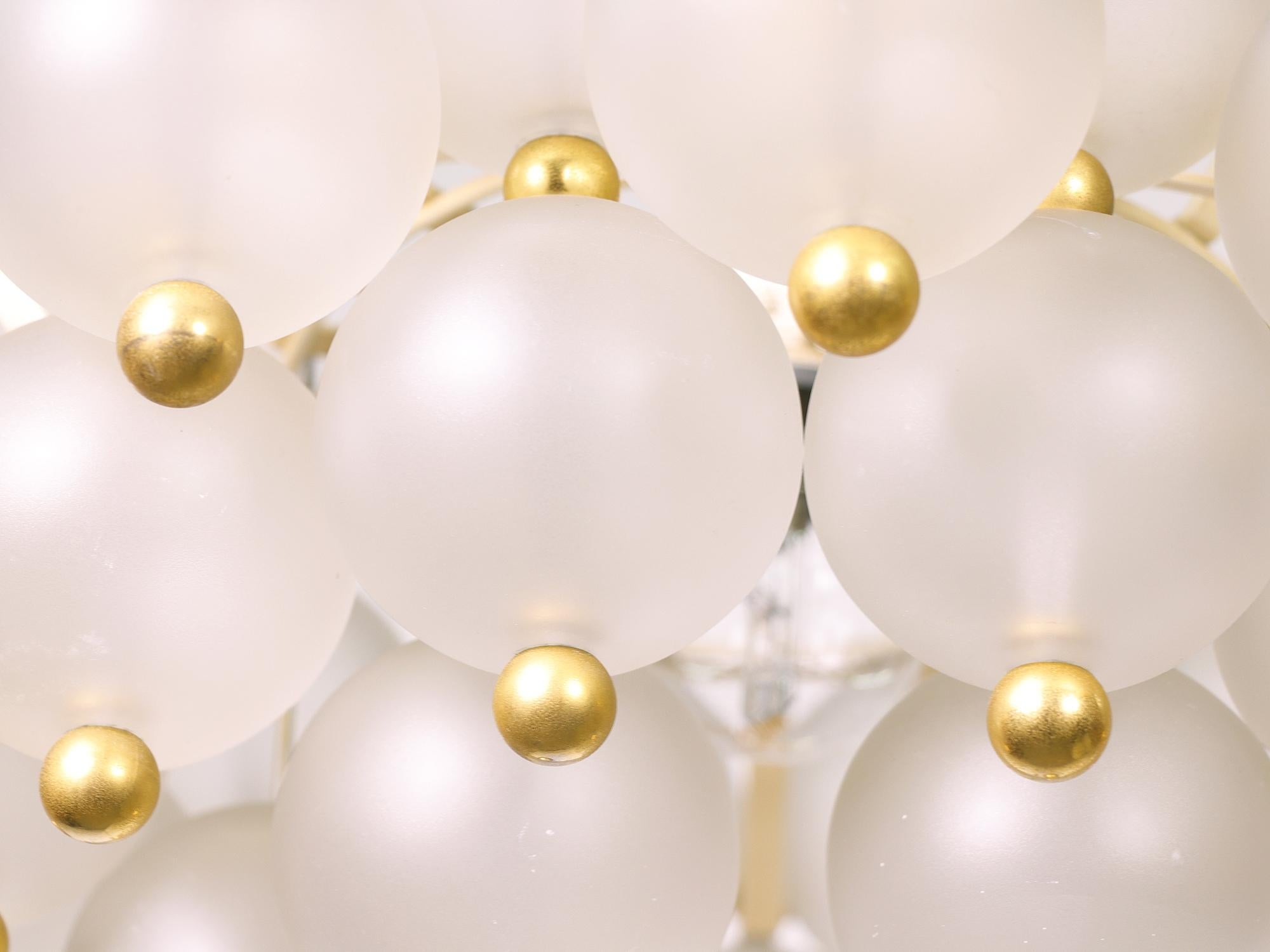 Elegant chandelier with handblown frosted glass balls with golden knobs on a white laquered frame. Chandelier illuminates beautifully and offers a lot of light. Gem from the time. With this light you make a clear statement in your interior design. A