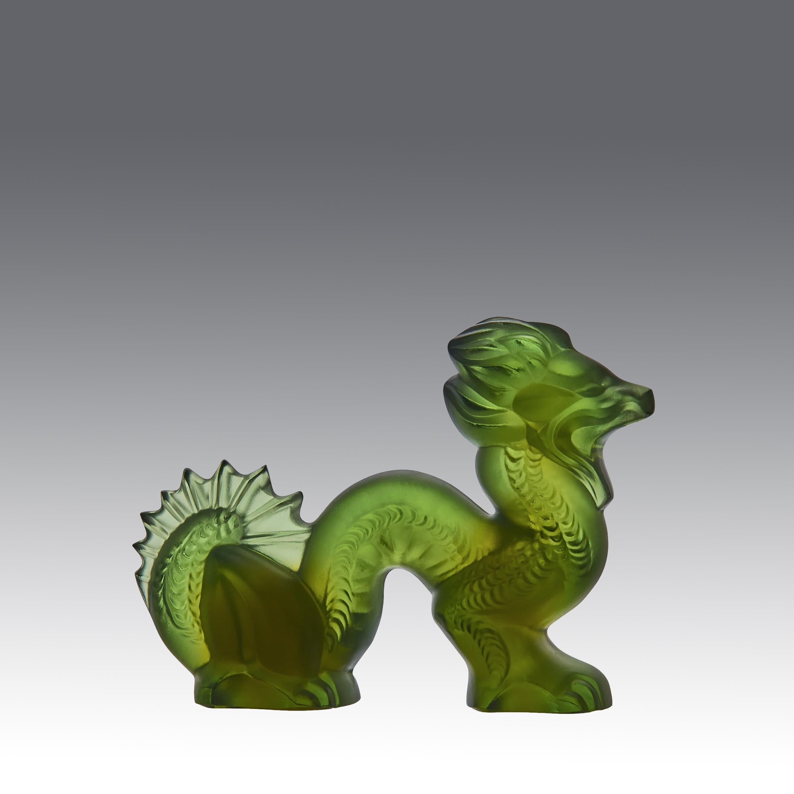 A very fine green glass Oriental dragon of undulating form with very fine hand chased surface detail and dramatic internal opalescent colour, signed Lalique France

ADDITIONAL INFORMATION
Height: 7 cm

Width: 10 cm

Condition: Excellent