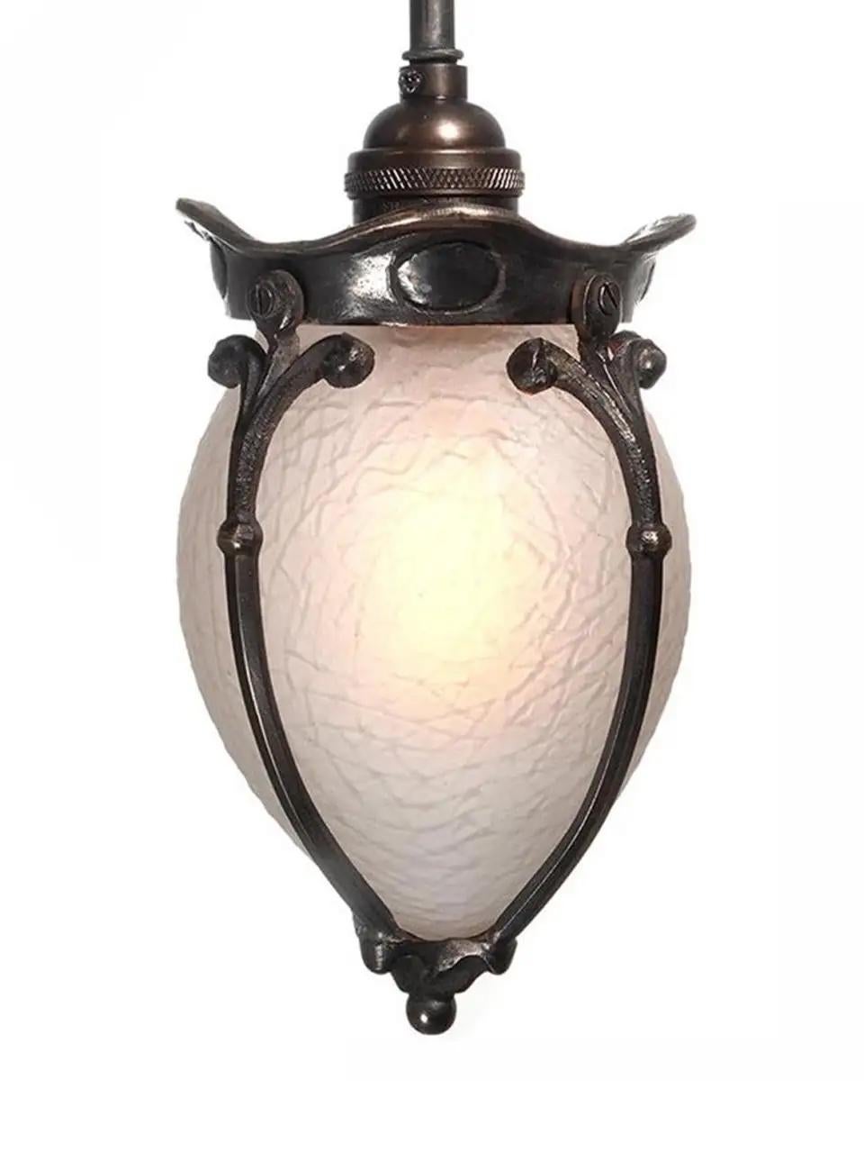 This is a petite and rich looking pendent. The glass has a frosted finish creating a nice warm glow and no bulb glair. The glass also has a unique stone patterned texture. The brass details that surround the glass are a thick casting that has a nice