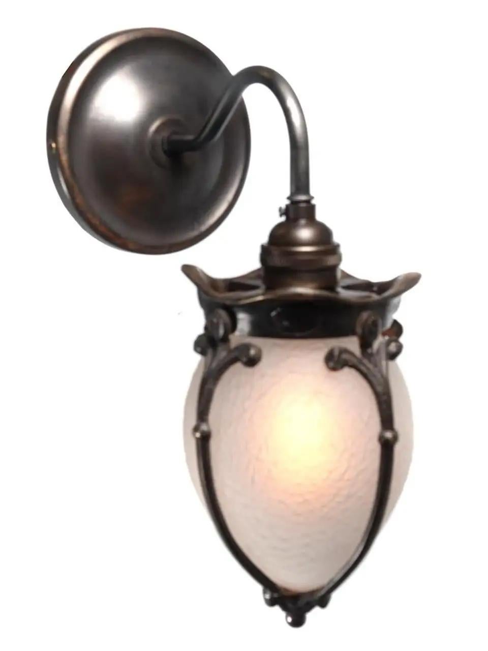 This is a petite rich looking sconce. The glass has a frosted finish creating a nice warm glow and no bulb glair. The glass also has a unique stone patterned texture. The brass details that surround the glass are a thick casting that has a nice