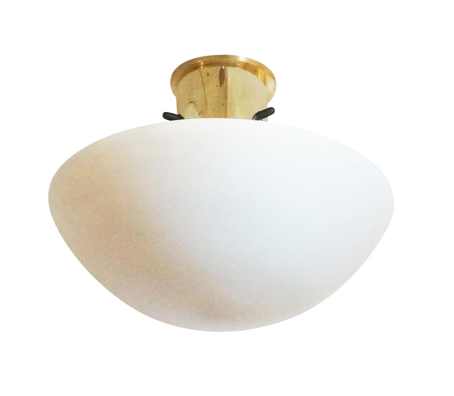 Italian Mid-Century flush mounts with a large frosted glass diffuser and brass hardware. Holds one light source. Two available-price per light. 

Condition: Excellent vintage condition, minor wear consistent with age and use.

Diameter: 15”

Height: