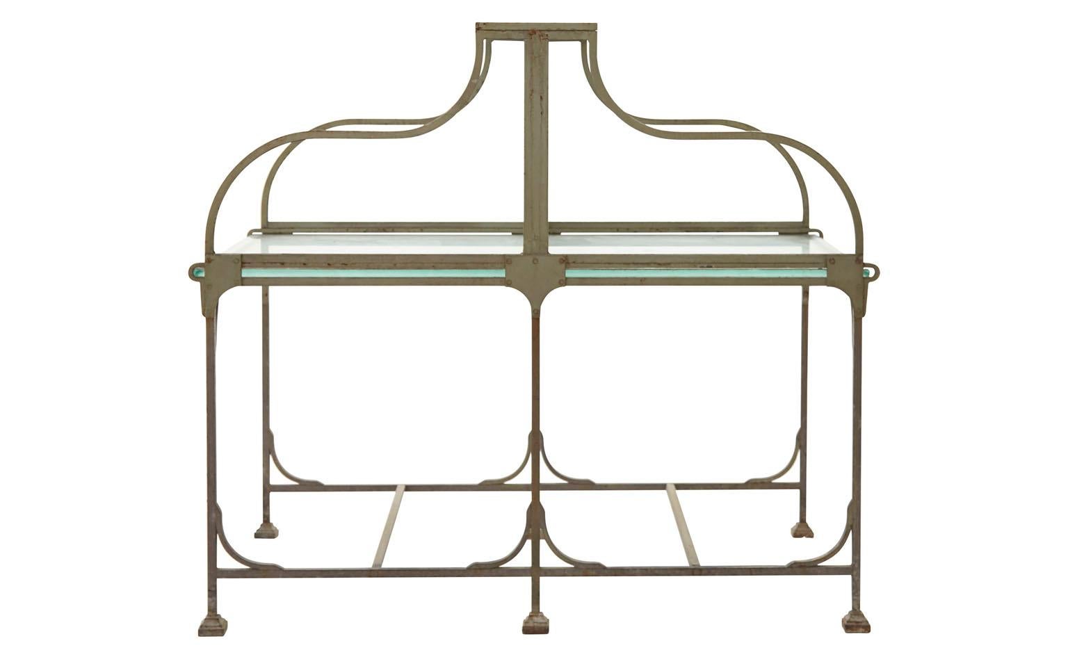 Crafted in the early 20th century, our Vintage Bank Desk was salvaged from a bank lobby in France. This double-sided desk features two original frosted glass tabletops, divided by another pane of frosted glass for privacy and surrounded by a curved