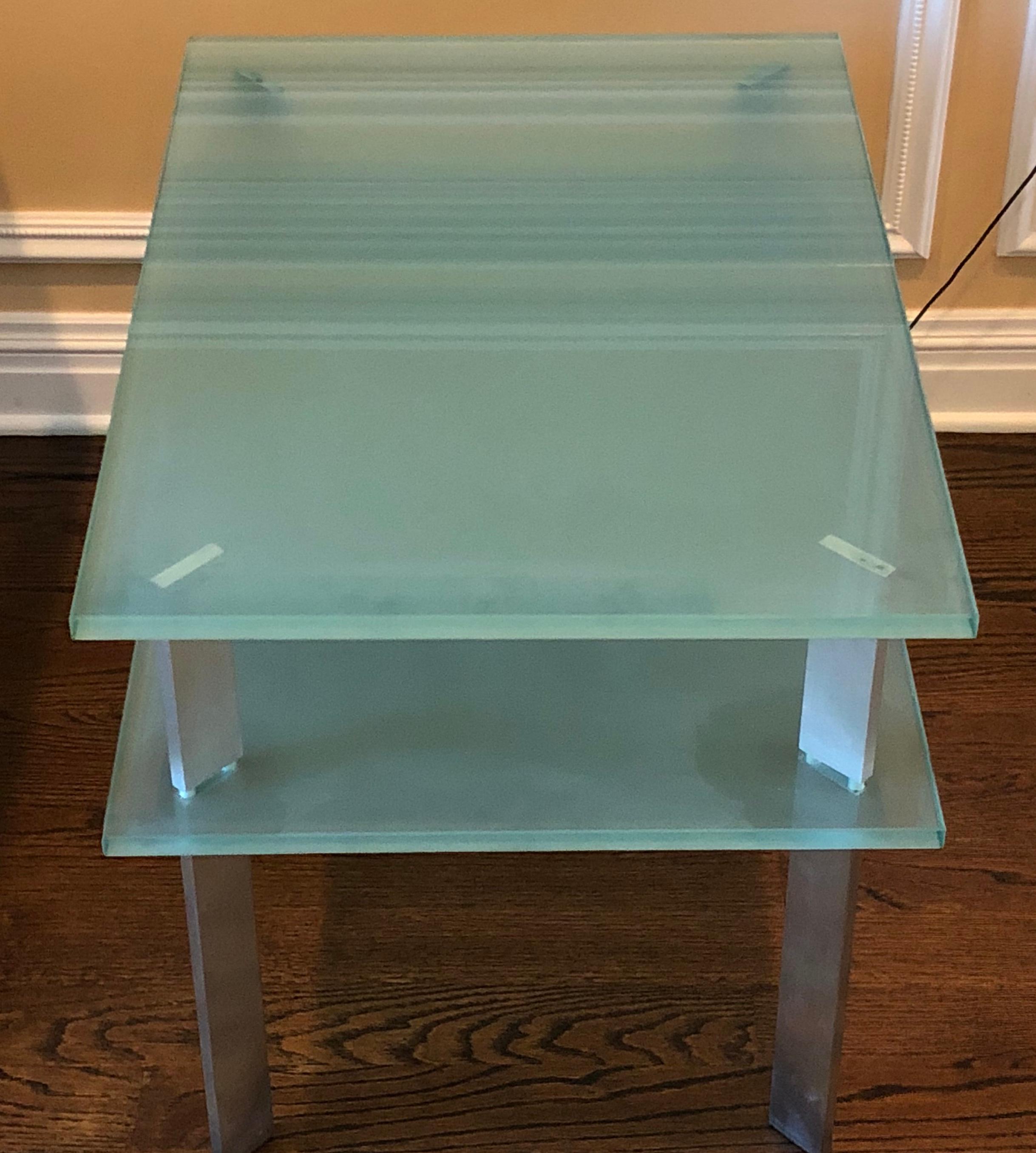 Frosted glass bi-level rectangular end table with matte aluminum legs. The lower shelf is 15.5
