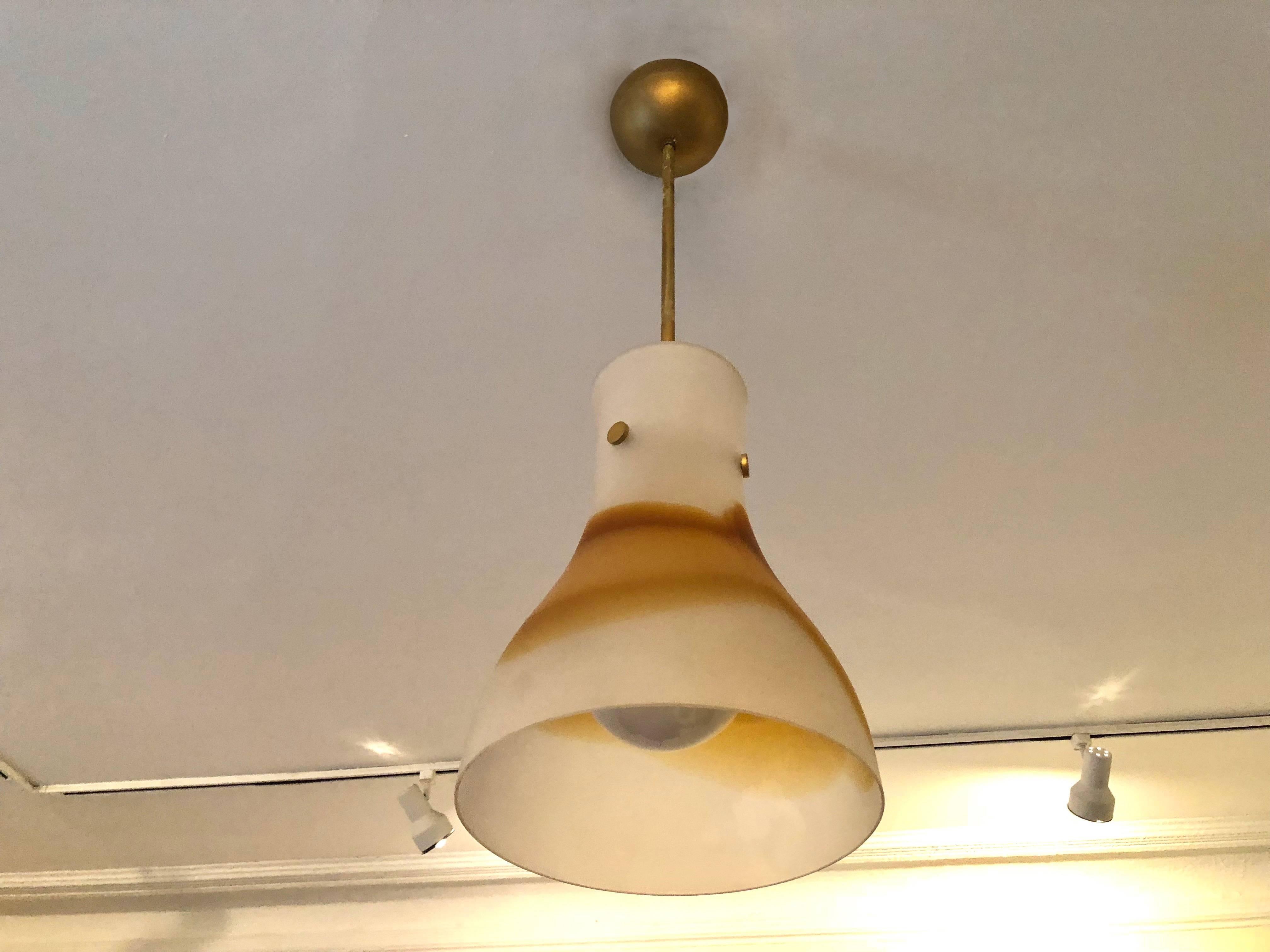 Italian ceiling light with a Murano glass shade of blown, white and orange frosted glass, that is suspended and held by brass hardware, three round brass knobs, a straight stem and original canopy. Single porcelain, standard US socket.
Overall drop