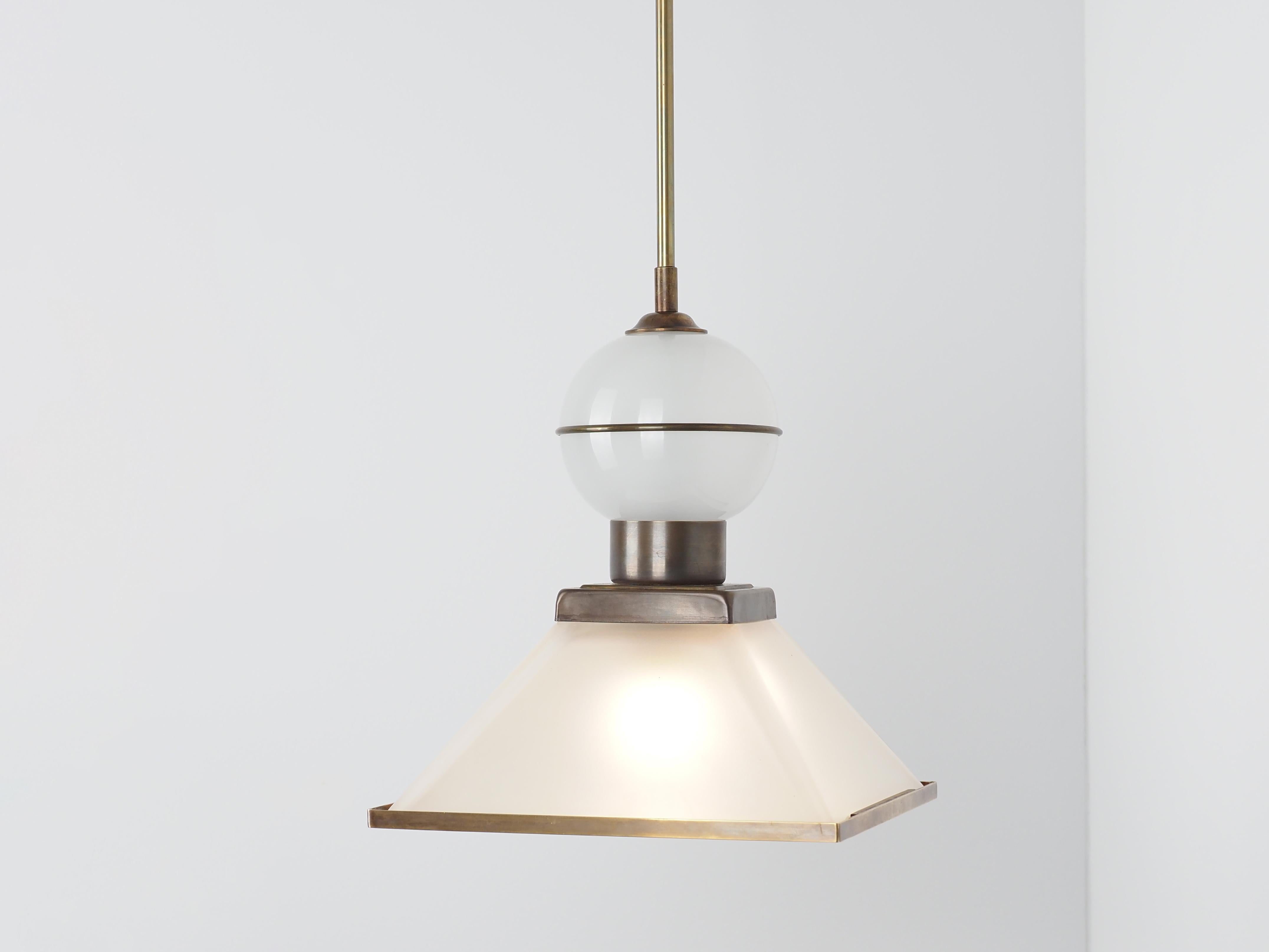Contemporary Italian pair frosted glass pendants
Pyramid shape with round white glass finial
Brass trim at the bottom square, center and in the middle of the round finial.
Overall height 37.5