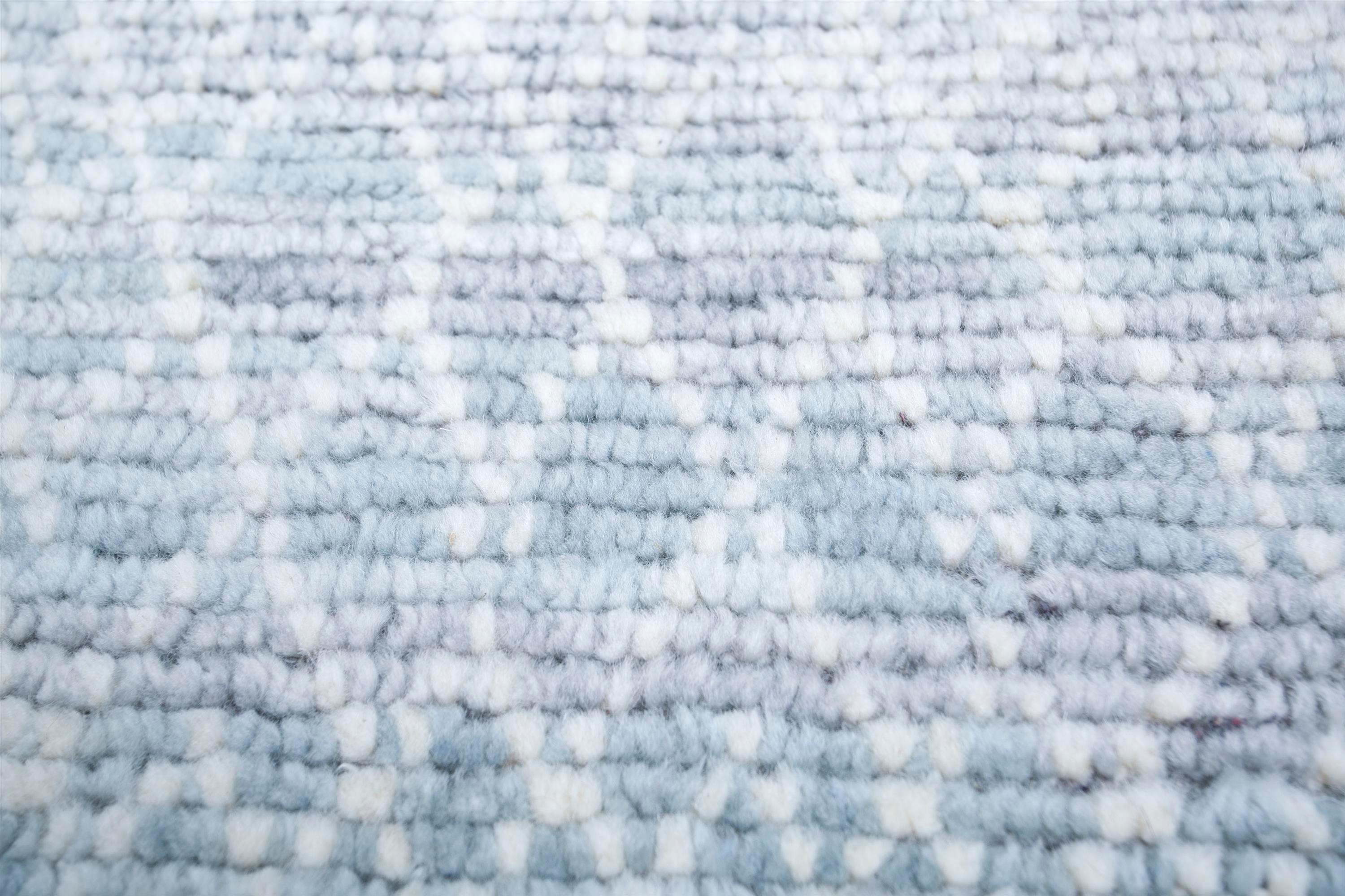 Step into a realm of fine elegance with this beautiful handmade carpet from our Kairos collection. Imagine the gentle whisper of windswept plains captured in the soft hues of white and medium blue, inviting you to tread upon a landscape of serenity.