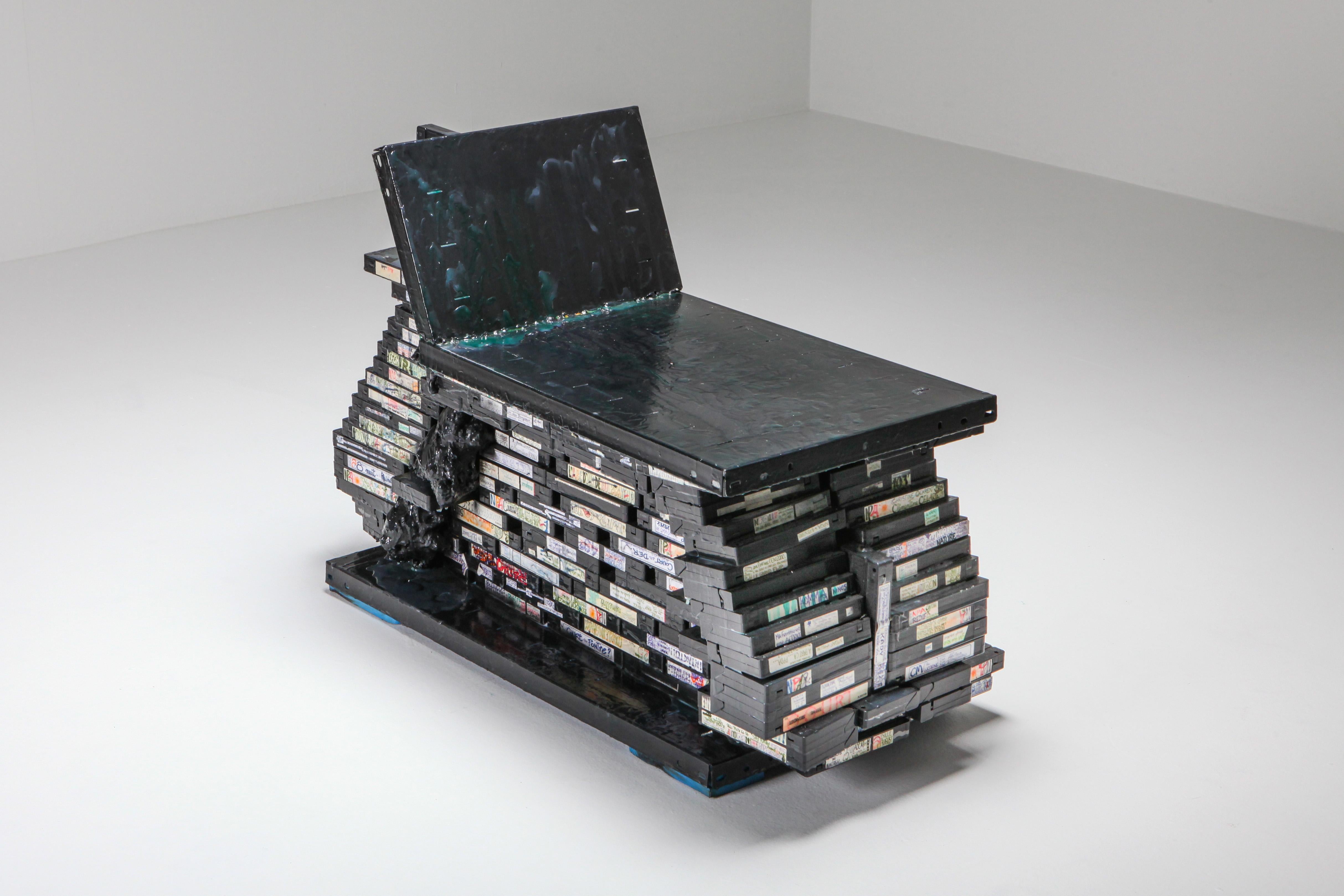 The ‘Frozen Culture’ chair is a unique functional art piece with a history. Constructed from a set of 35,000 VHS cassettes that were recorded over the course of 25 years by an individual and later bought by Lionel Jadot. The collector was a graphic
