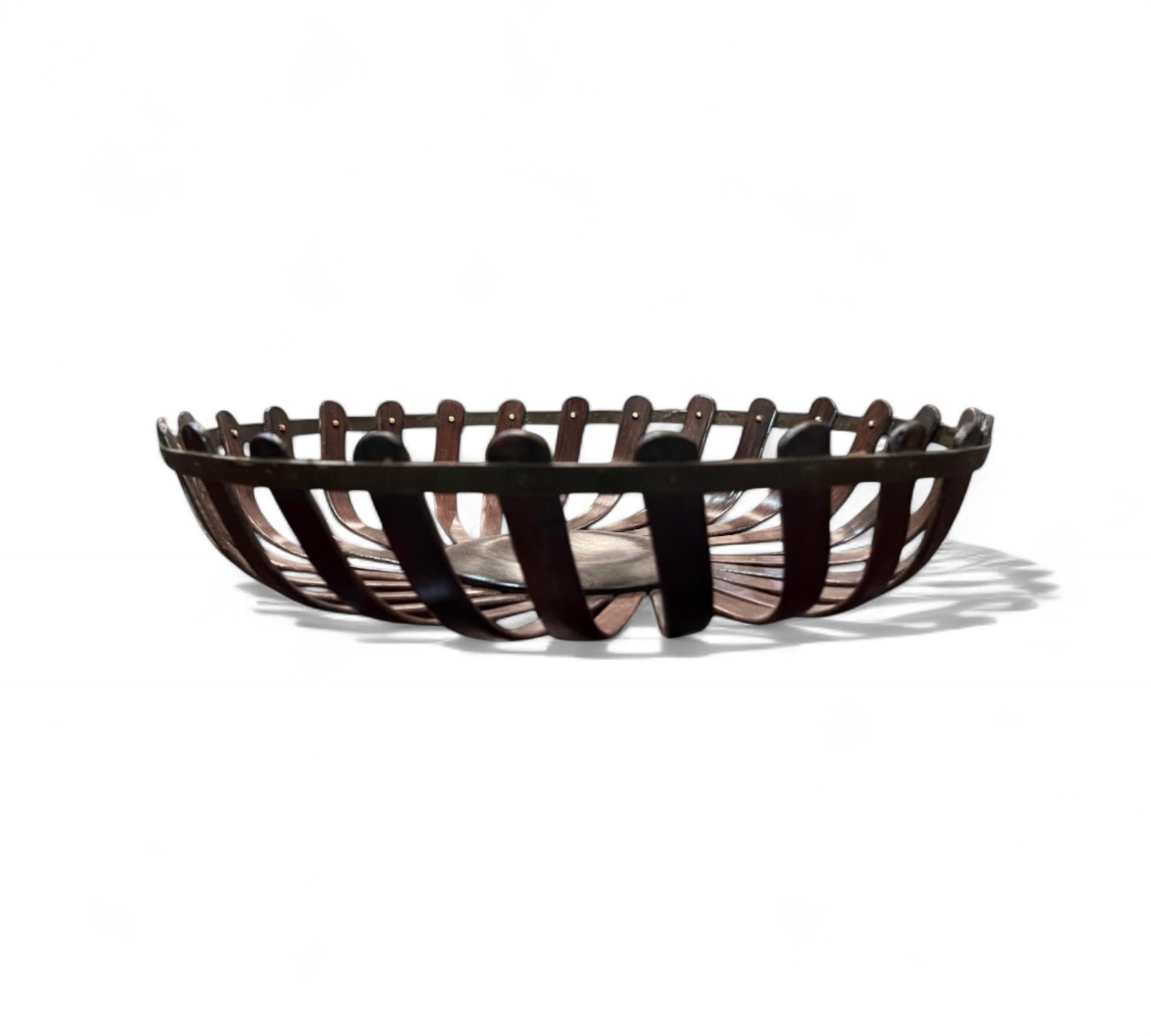 This midcentury Brazilian modern decorative fruit basket was made in Brazil circa 1960. Handcrafted with hardwood, this elegant fruit basket features a circular shape consisting of bentwood and copper pins. 

Pieces like this, with a minimalist
