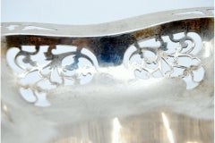 Fruit bowl in cut silver and resting on four smooth feet