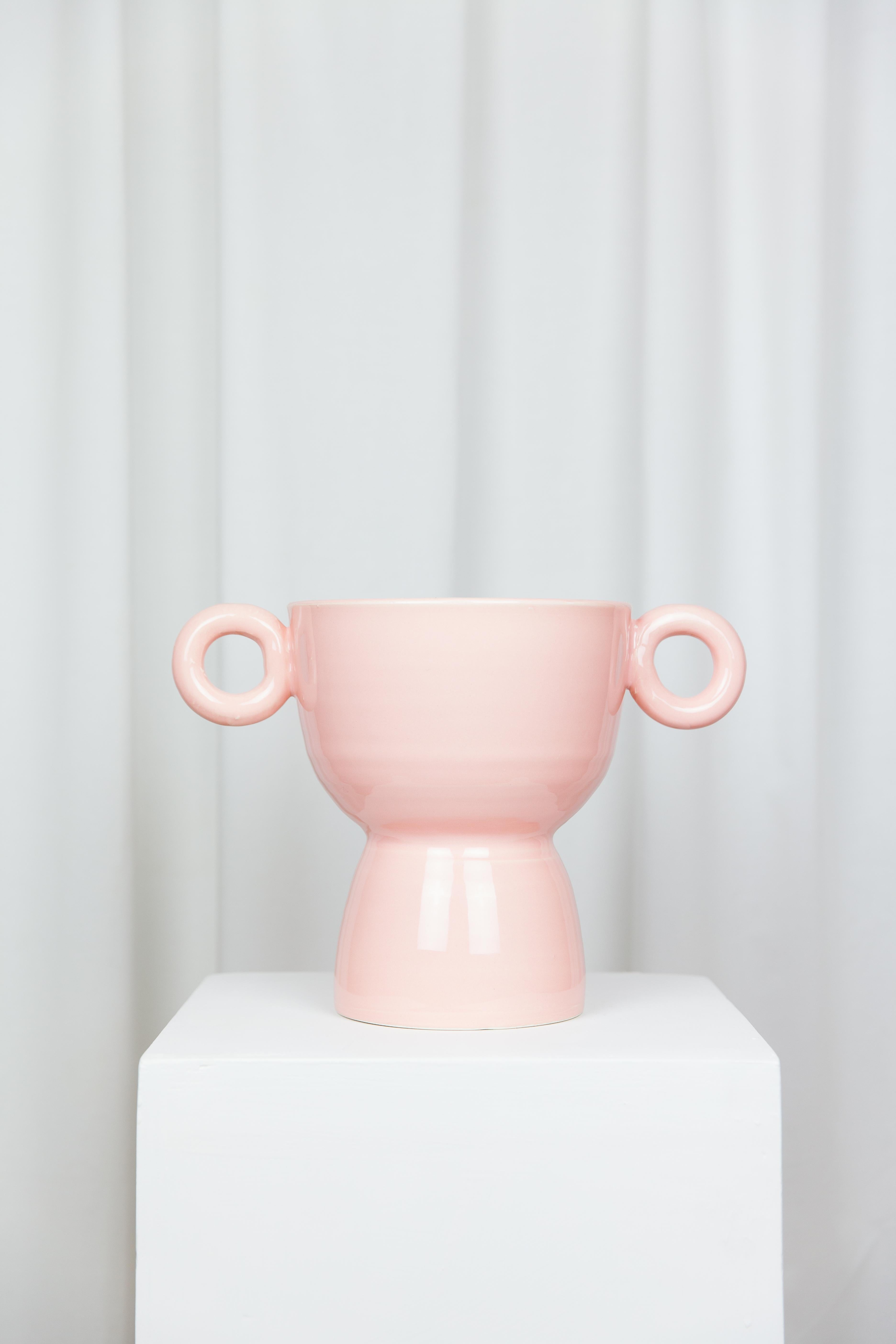 Fruit cup by Lola Mayeras
Dimensions: D 33 x W 20 x W 24 cm
Materials: Earthenware.

Fruit bowl in white earthenware, glazed in
pink. This piece is designed and handcrafted in the south of France.

Lola Mayeras — Designer 
In parallel with