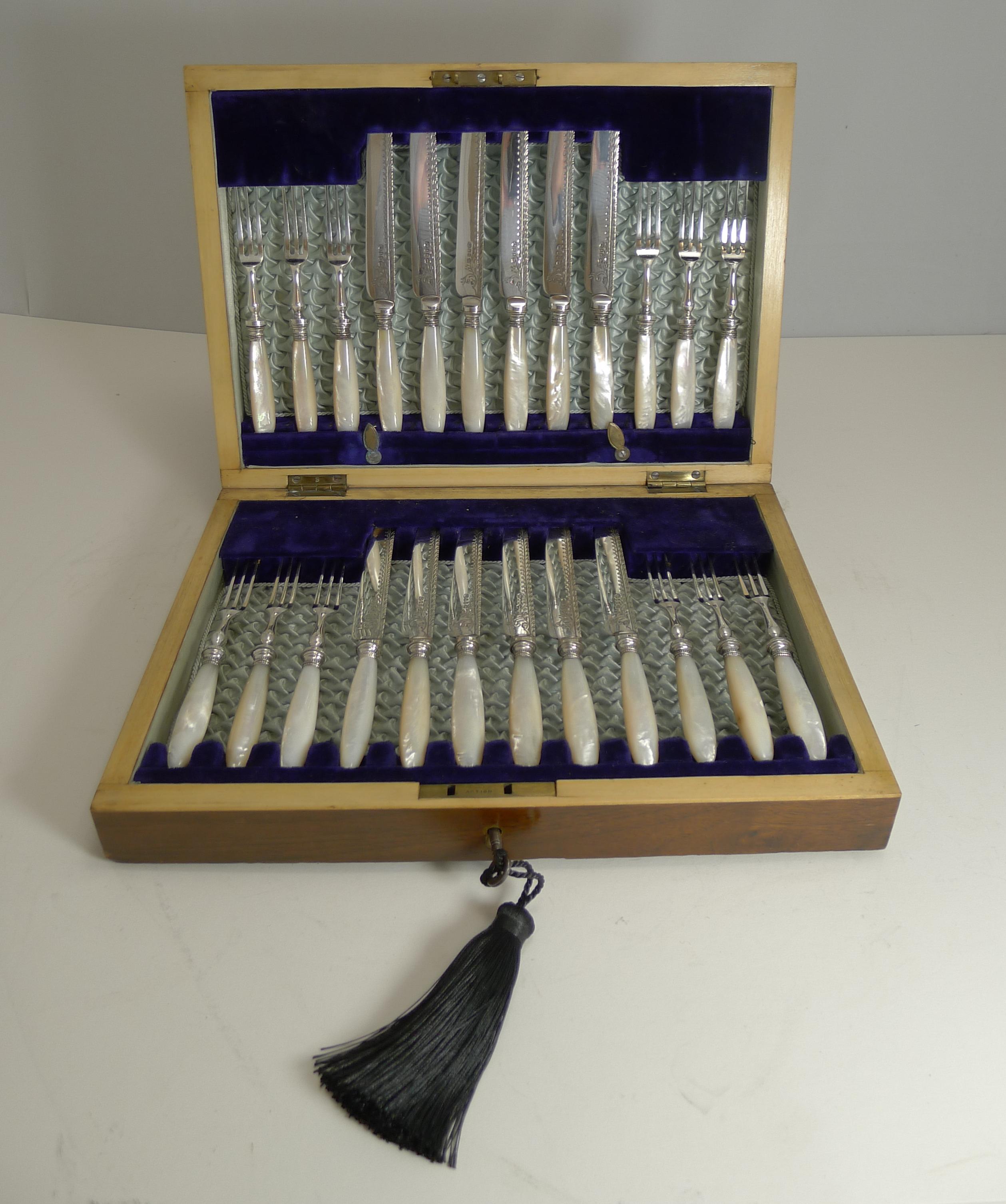 A fabulous set of twelve of elegant fruit knives and forks made from silver plate with carved and polished mother of pearl handles.

The blades to the knives have decorative engraving and each signed with the makers mark for the well renowned