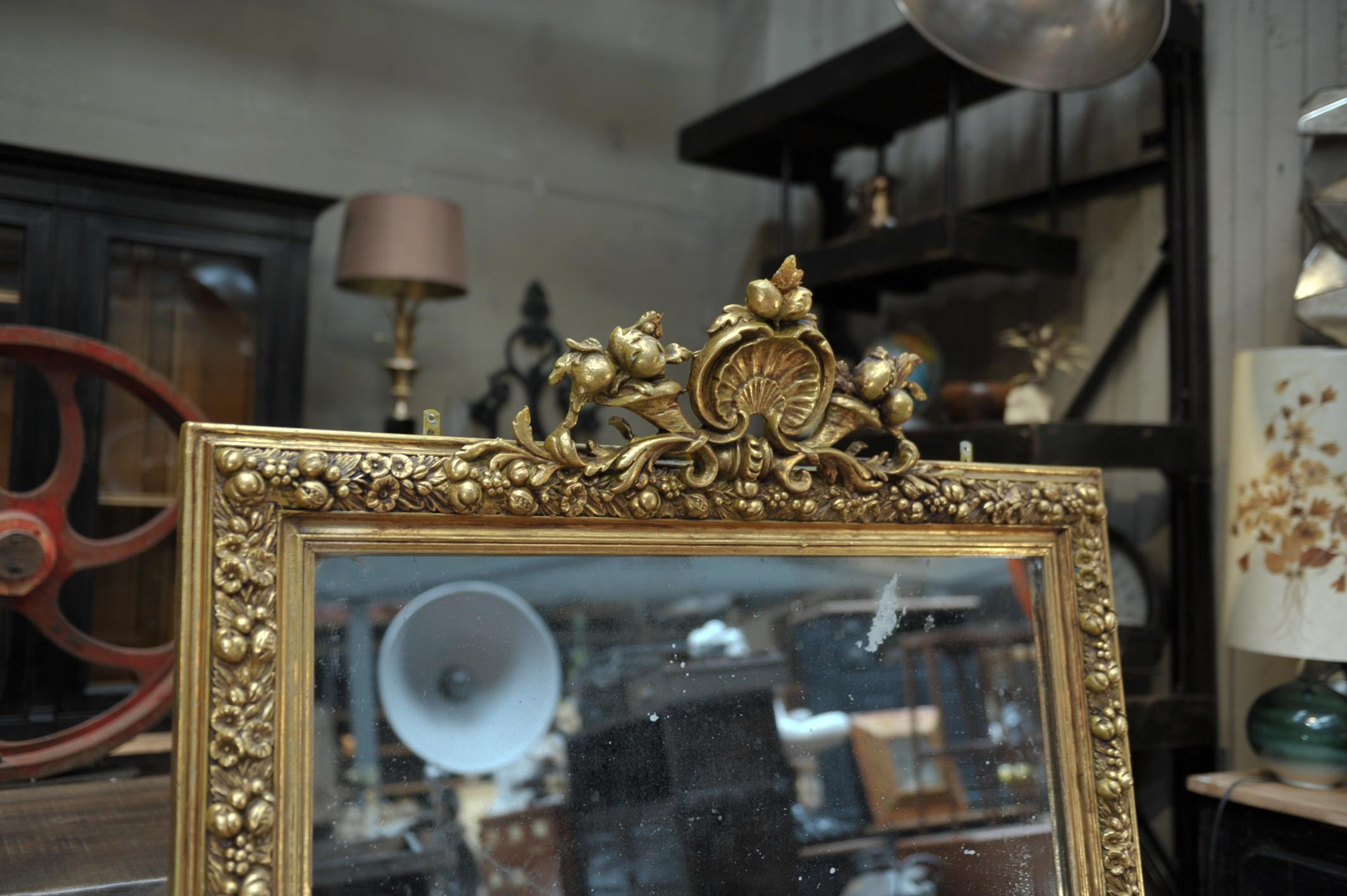 Late pine gilt wood mirror Louis XV style with fruits decor, circa 1880.