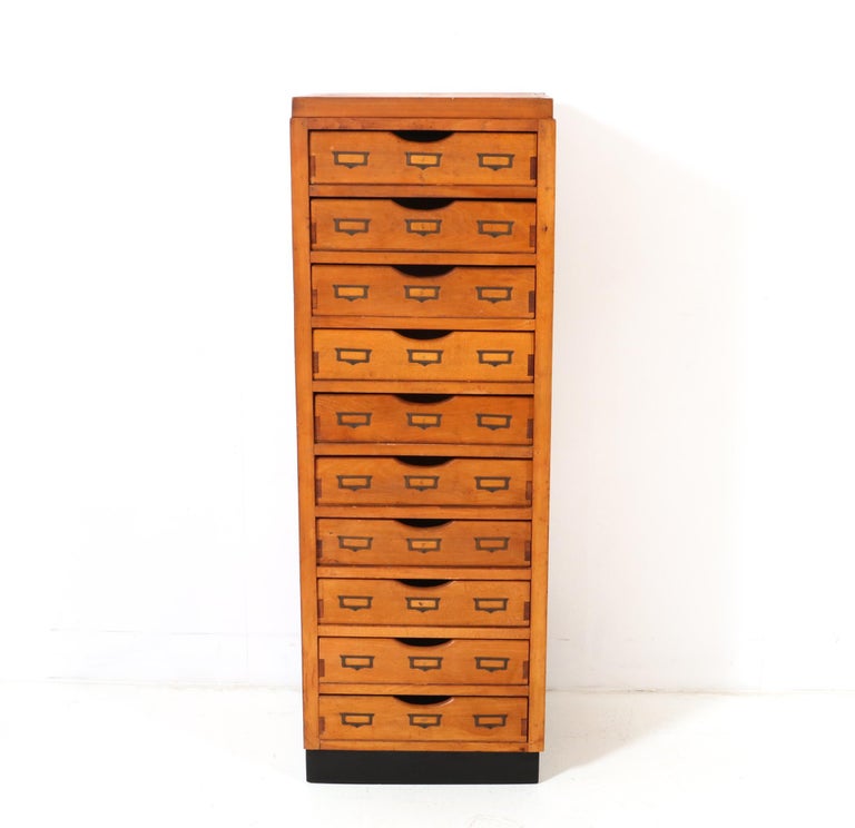 Stunning Art Deco Haberdashery chest of drawers.
Striking Dutch design from the 1920s.
Fruitwood base with ten original drawers on a black lacquered stand.
All ten drawers have the original brass label holders.
This wonderful Art Deco