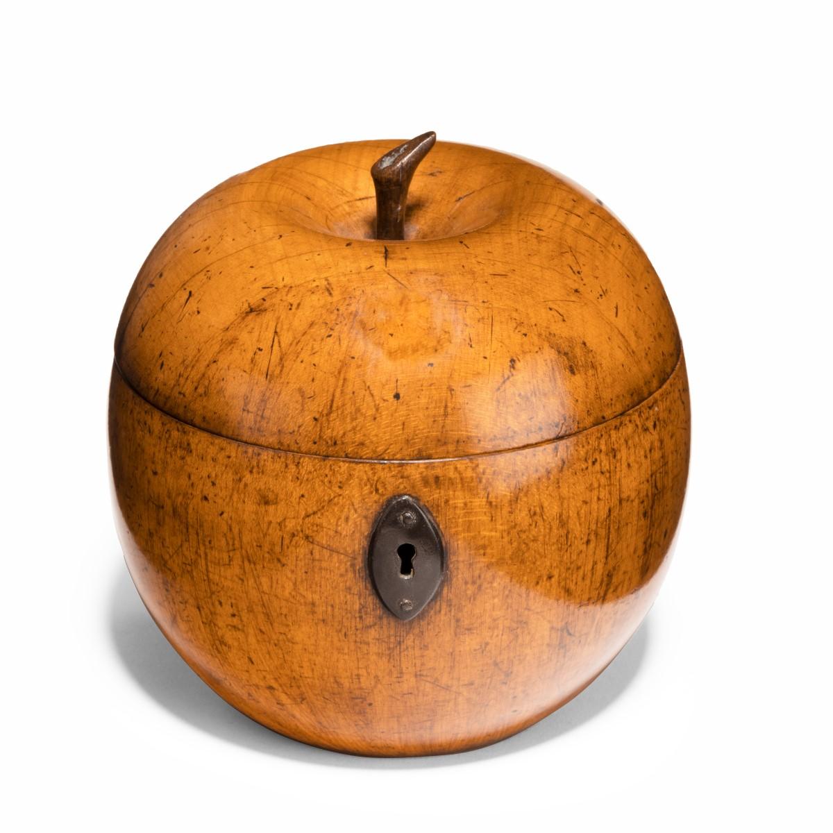 A fruitwood tea caddy in the form of an apple, with steel hinge and lock plate, the wood a sensational color, probably Continental, circa 1800.
 