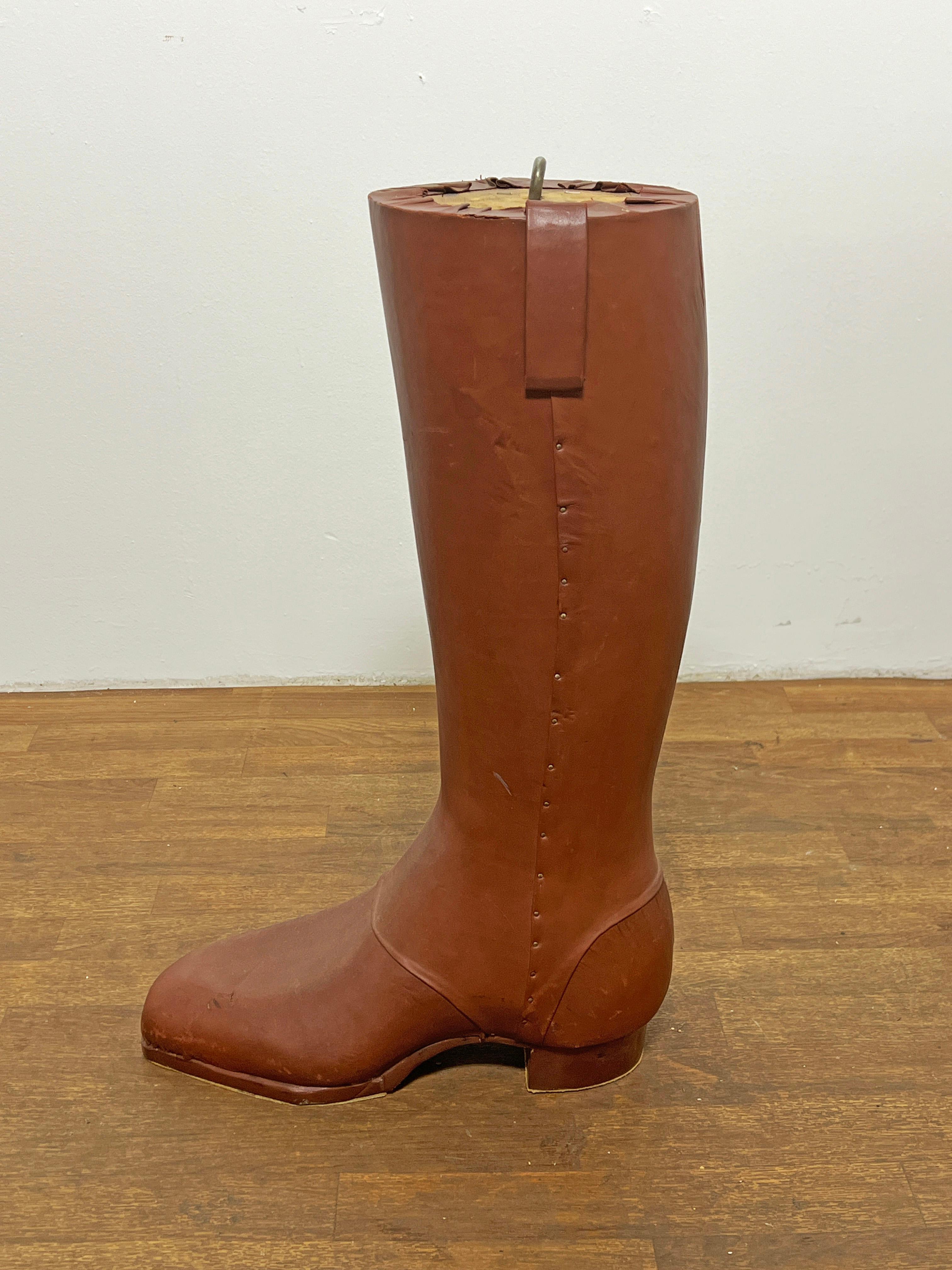 A hangable advertising icon for the Frye Boot Company in the form of an oversized leather boot, circa 1960s.  This once hung in the renowned favorite Harvard Square Tannery shoe store in Cambridge, MA from the 1960s to the early 1980s when it was