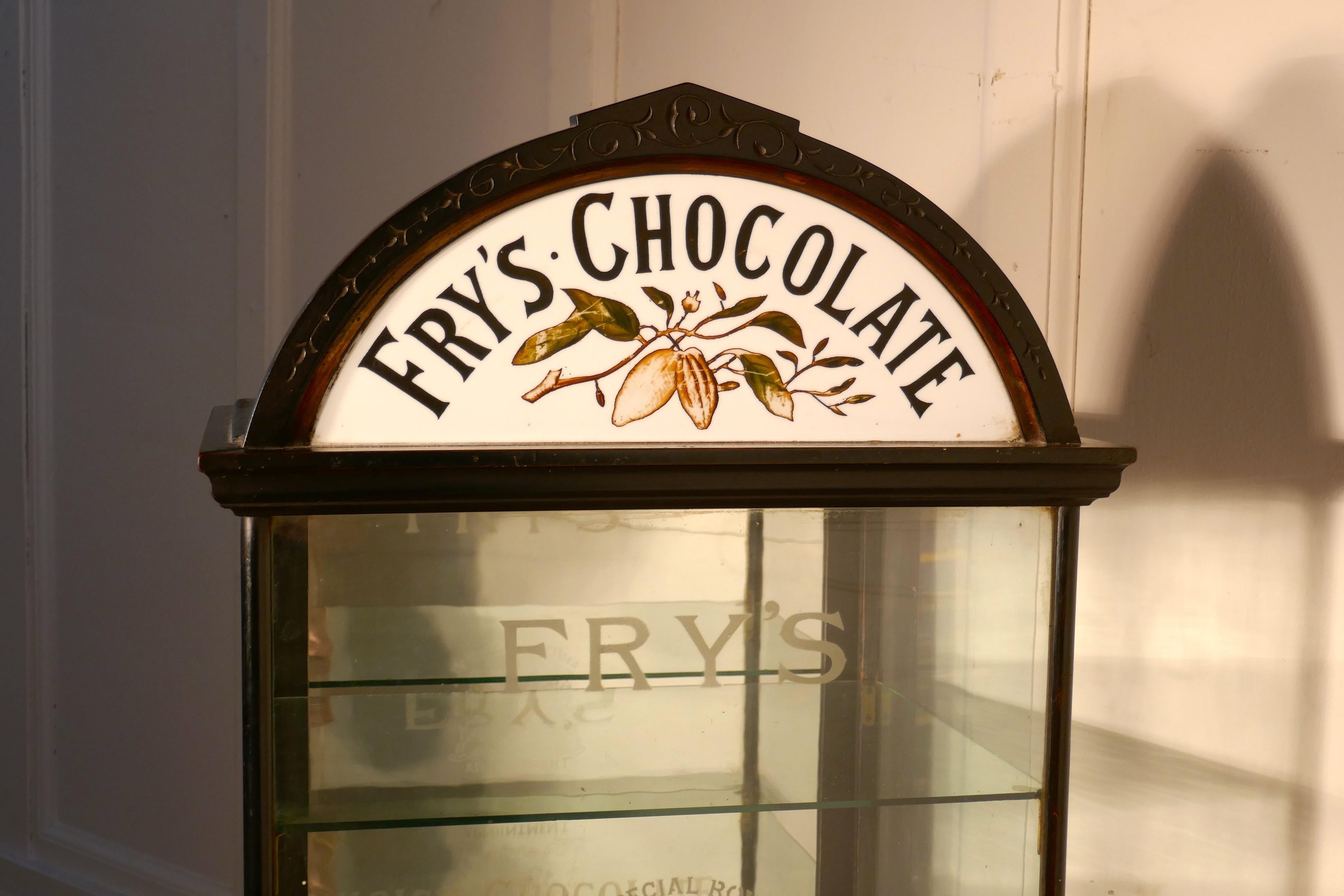 Fry’s chocolate sweet shop display cabinet, by R Palmer Bristol

This glazed advertising shop display cabinet it has an ebonized finish, the cabinet has a rather grand arching cornice. The cornice is inset with a half moon etched glass painted and