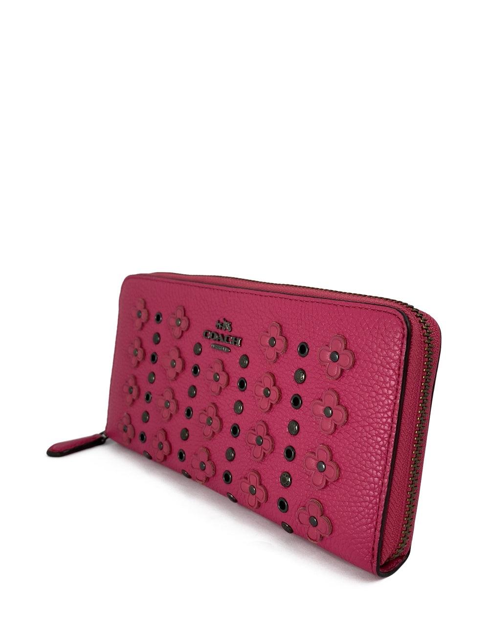 Fuchsia pink Coach wallet with flower and black stud detail, includes 5 slide compartments, one zipper compartment, and 12 card compartments on the inside. In excellent condition.

Additional information:
Material: leather 
Measurements: 19.5 W x 2