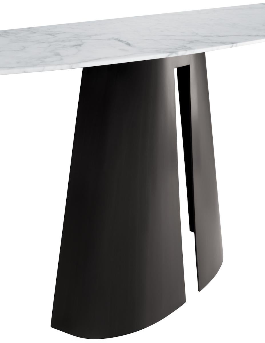 Console with elongated demilune stone top and tapered and bisected hand-forged steel cone base.

Shown with Bianco Carrara marble top with a modern bronze base. 

Natural stone top options include: Bianco Carrara marble, Statuario marble,