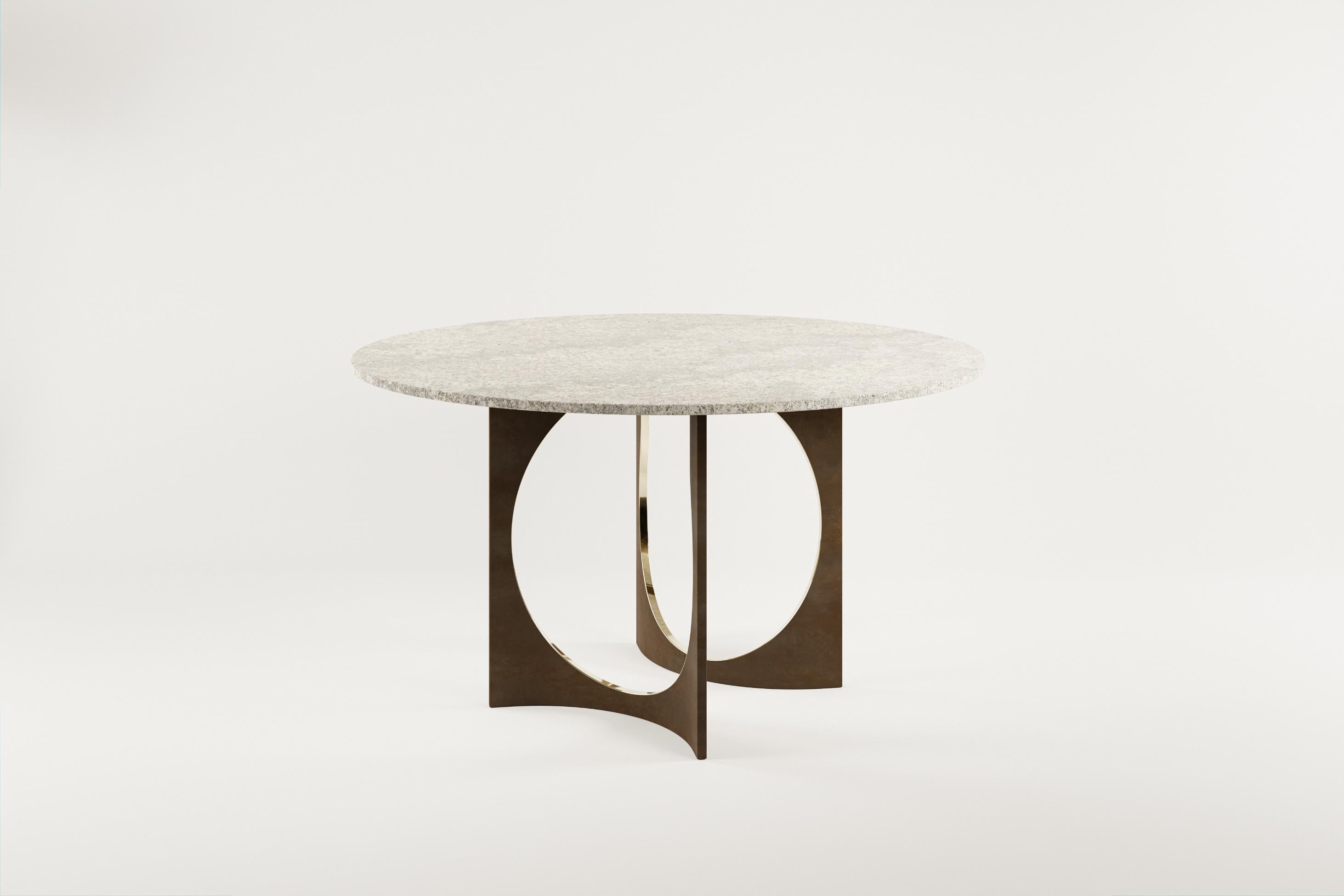 Round Patina Fuga Dining Table with Stone Top by Metamorphic Art Studio
Dimensions: ⌀ 140 x H 78 cm
Materials: Cast Bronze with Patina, Stone

The Fuga table is a sculptural table with timeless elegance. The base is handcrafted in Belgium from four