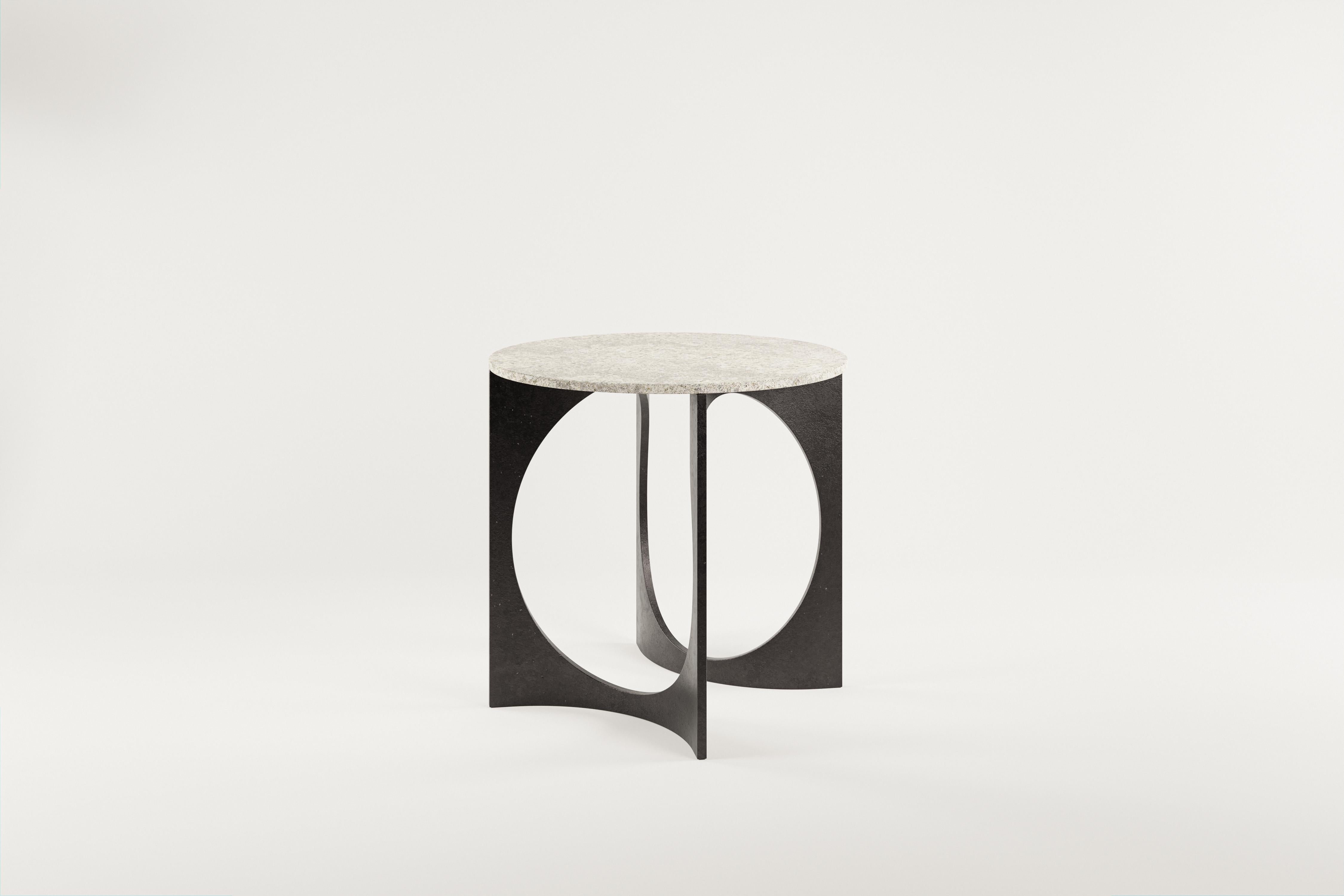 Round Fuga Breakfast Table in Cast Iron and Stone Top by Metamorphic Art Studio
Dimensions: ⌀ 80 x H 76 cm
Materials: Stone, Cast Iron

The Fuga table is a sculptural table with timeless elegance. The base is handcrafted in Belgium from four